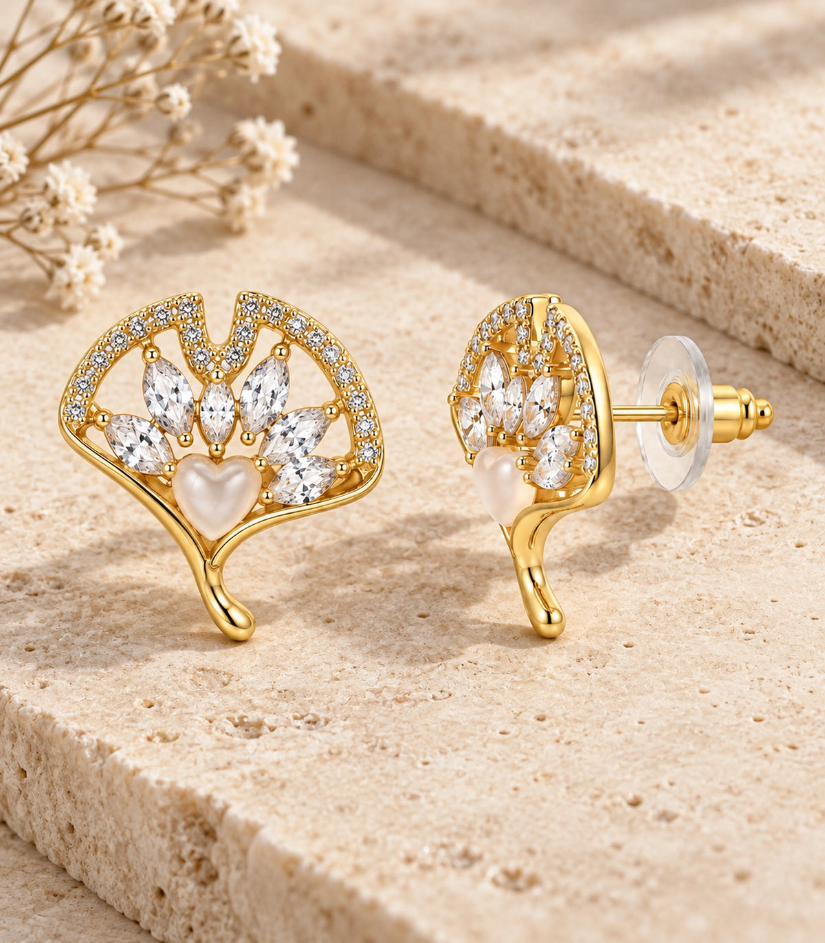 JIMIKI Gold-Tone Crystal Ginkgo Leaf Heart-Accent Stud Earrings in Gold / Clear / Milky White, editorial flat lay