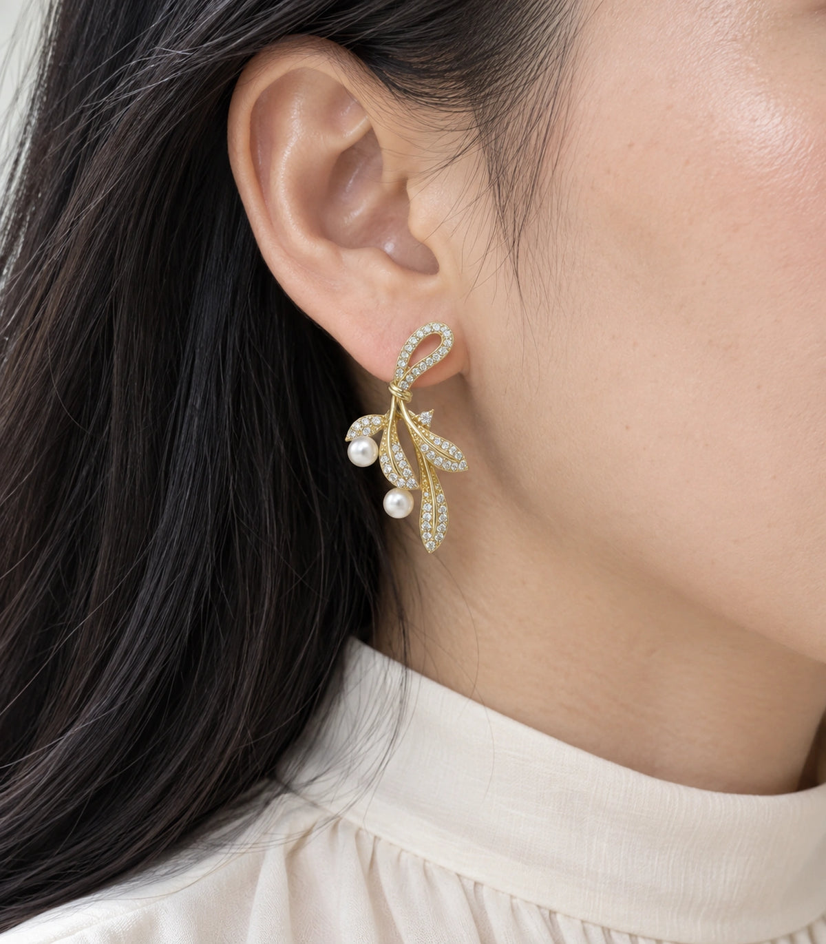 JIMIKI Crystal Leaf Two Pearl Drop Earring Pair in Gold-tone, close-up detail #color_gold-tone