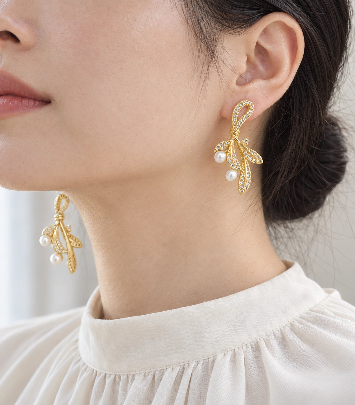 JIMIKI Crystal Leaf Two Pearl Drop Earring Pair in Gold-tone, model wearing view #color_gold-tone