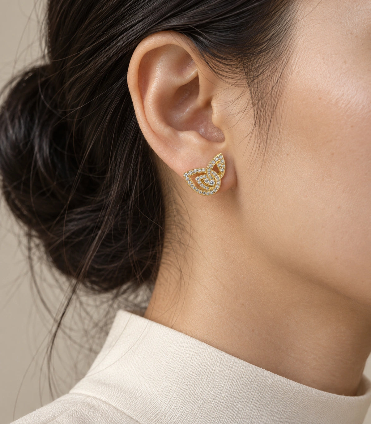 JIMIKI Crystal Open Swirl Stud Earring Pair in Gold tone, editorial model view #color_gold tone