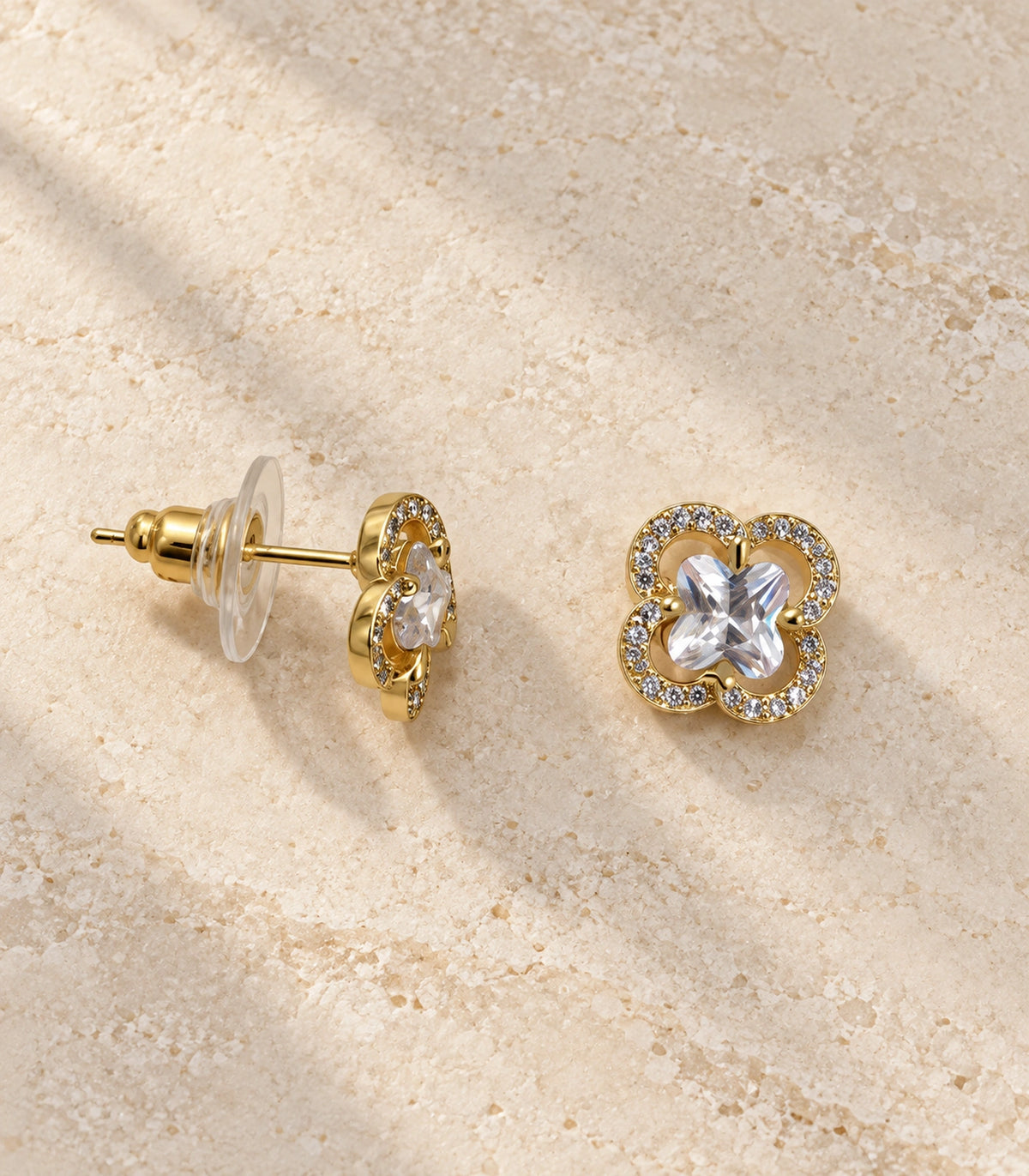 JIMIKI Crystal Quatrefoil Halo Stud Earring Pair in Gold Tone, editorial flat lay #color_gold tone