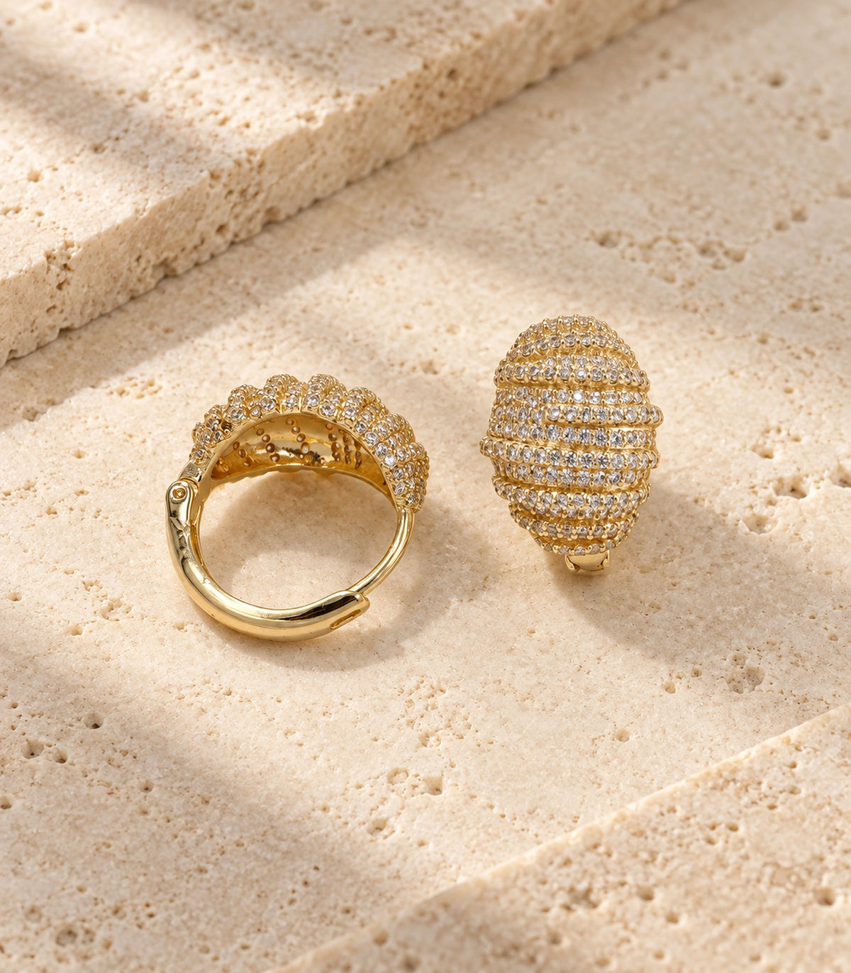 JIMIKI Crystal Ribbed Dome Huggie Earrings in Gold / Clear, editorial flat lay #color_gold / clear