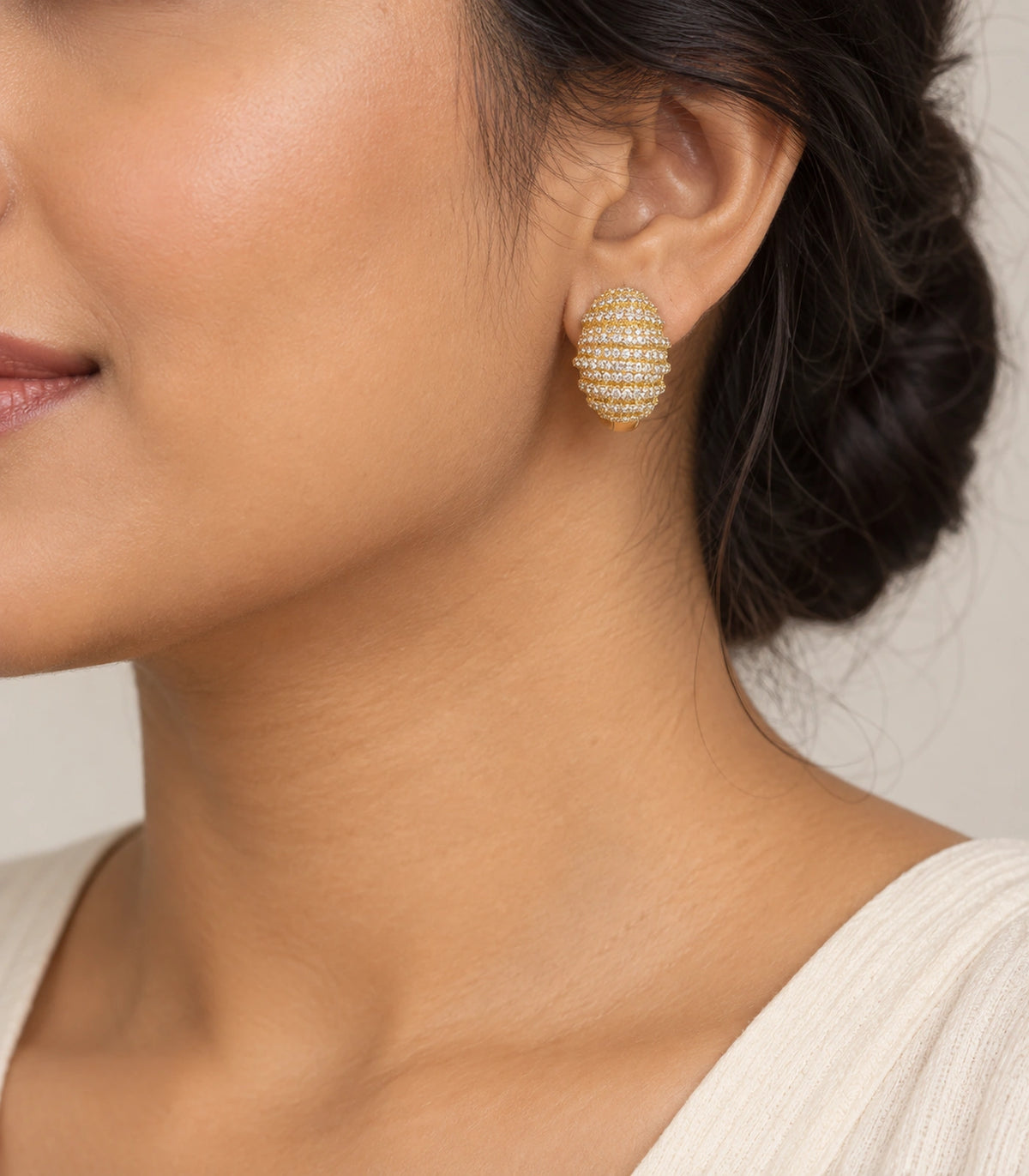 JIMIKI Crystal Ribbed Dome Huggie Earrings in Gold / Clear, model wearing view #color_gold / clear