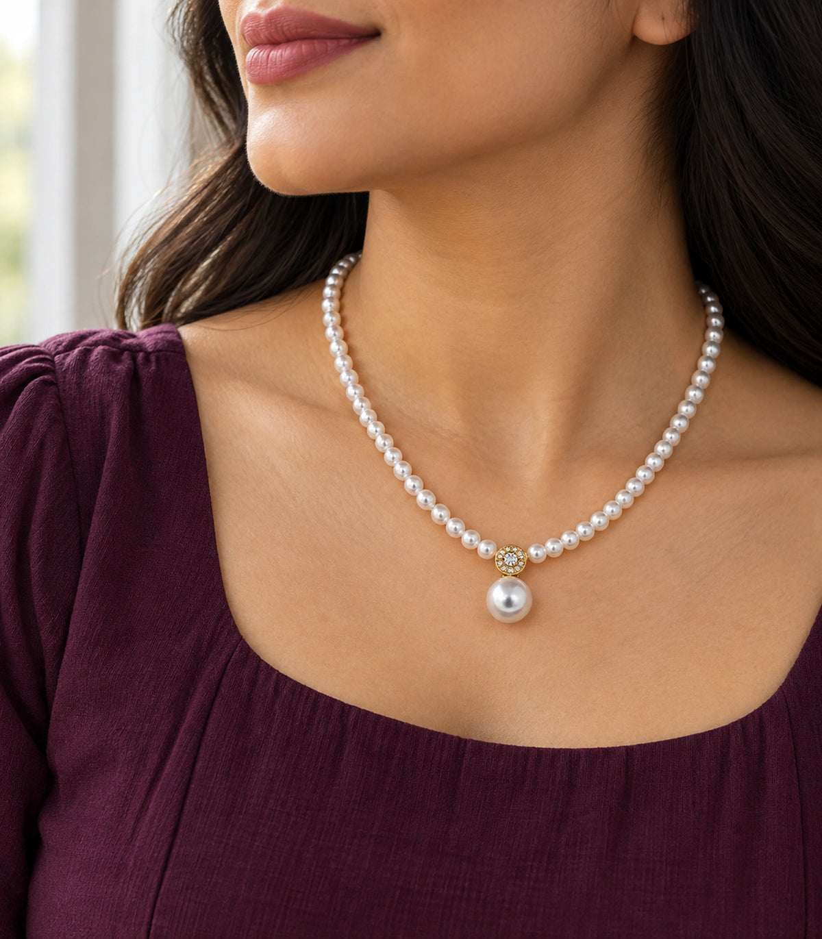 JIMIKI Gold Tone Crystal Rosette Pearl Drop Necklace in Gold / White, editorial model view