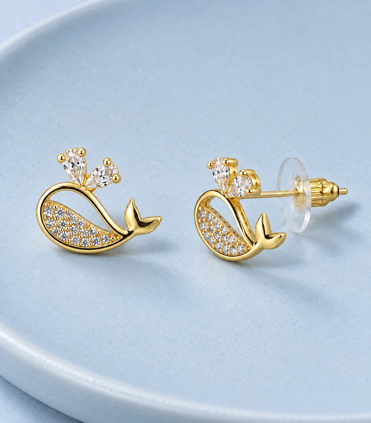 JIMIKI Crystal Whale Stud Earring Pair in Gold-tone, editorial flat lay #color_gold-tone
