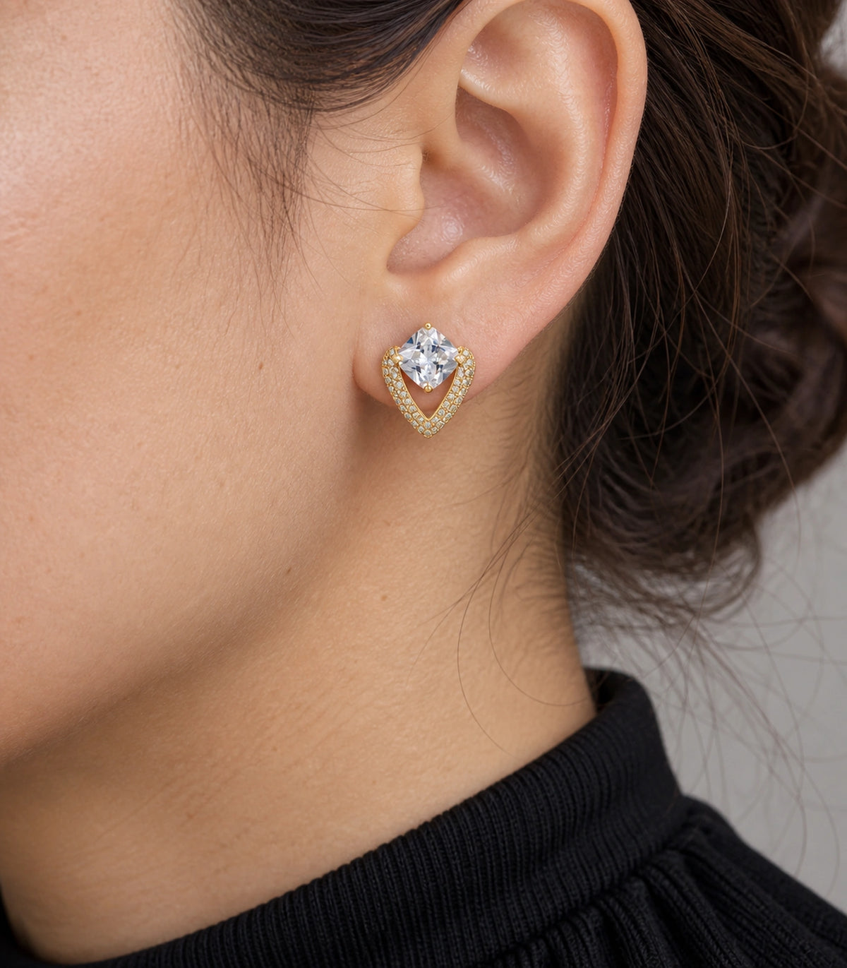 JIMIKI Gold Tone Cushion Crystal V Frame Stud Earring Pair in Gold-tone, close-up detail