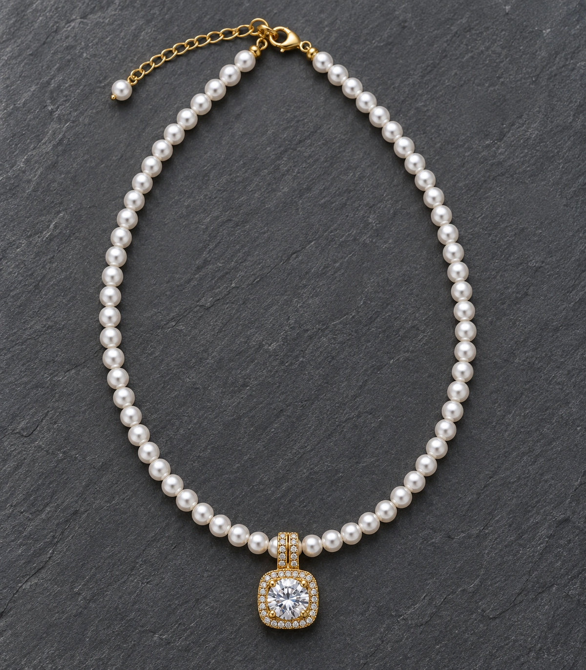 JIMIKI Gold Tone Cushion Halo Crystal Pearl Style Necklace in Gold tone / white, editorial flat lay