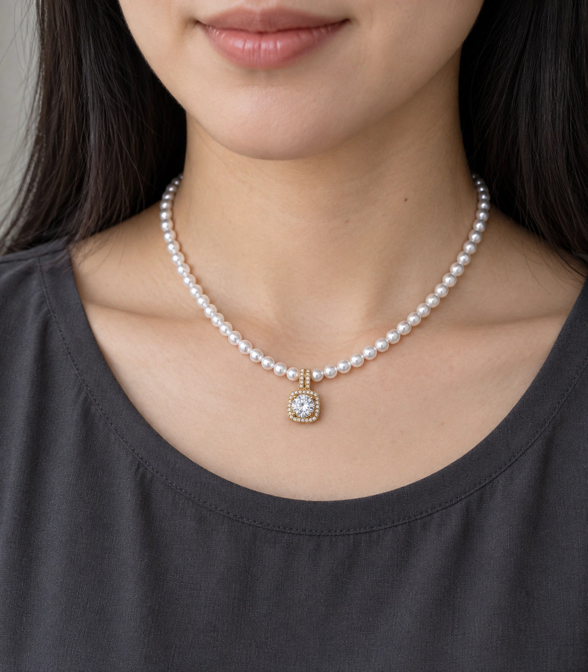 JIMIKI Gold Tone Cushion Halo Crystal Pearl Style Necklace in Gold tone / white, model wearing view