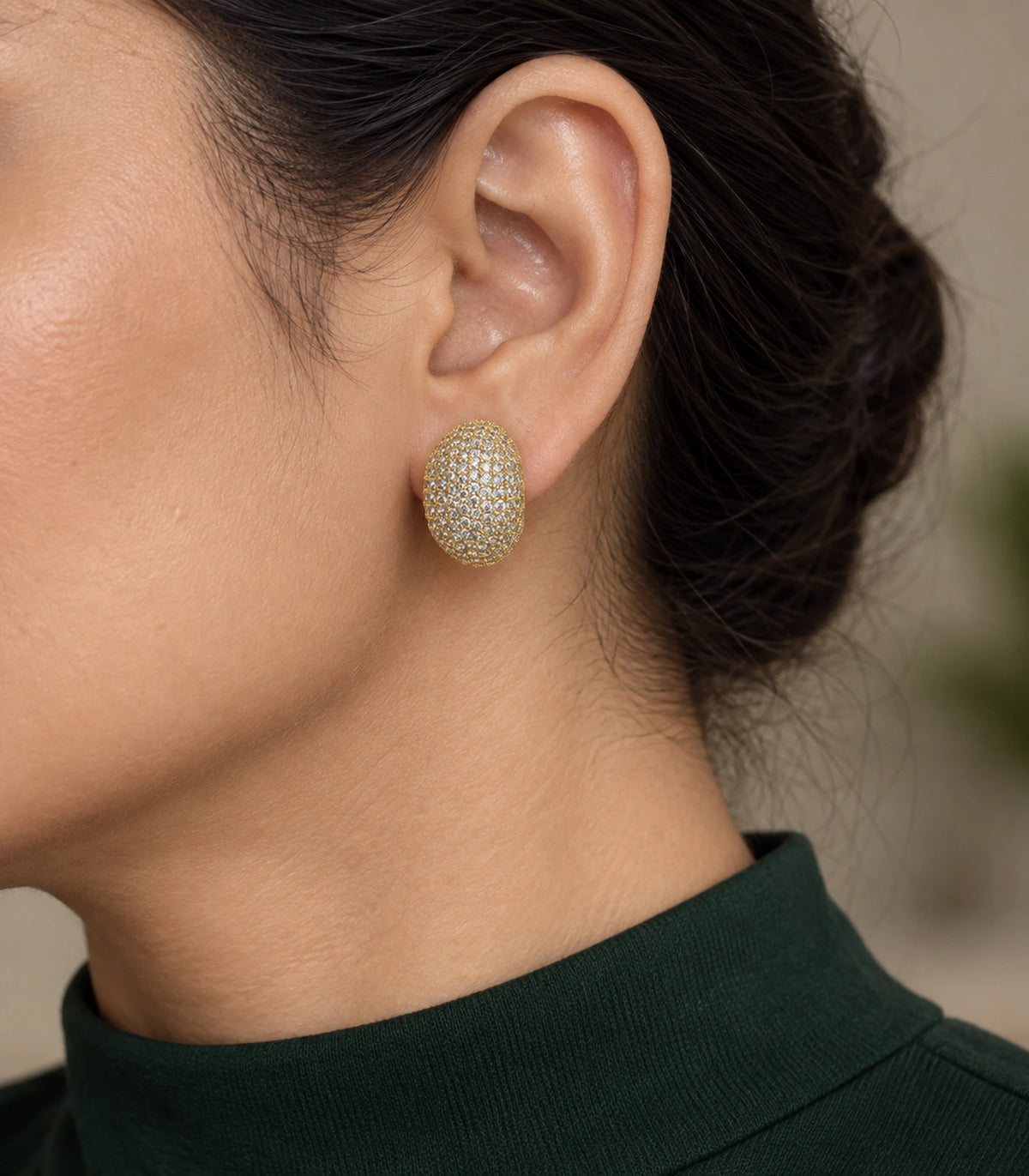 JIMIKI Domed Pave Oval Stud Earring Pair in Gold Tone, model wearing view #color_gold tone
