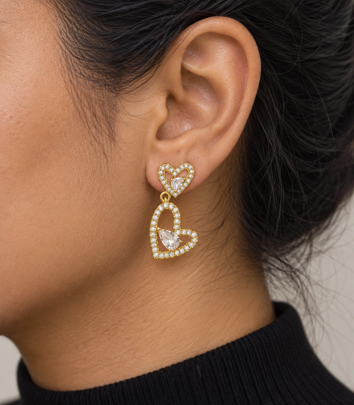 JIMIKI Double Heart Pear Crystal Drop Earrings in Gold Tone, model wearing view #color_gold tone