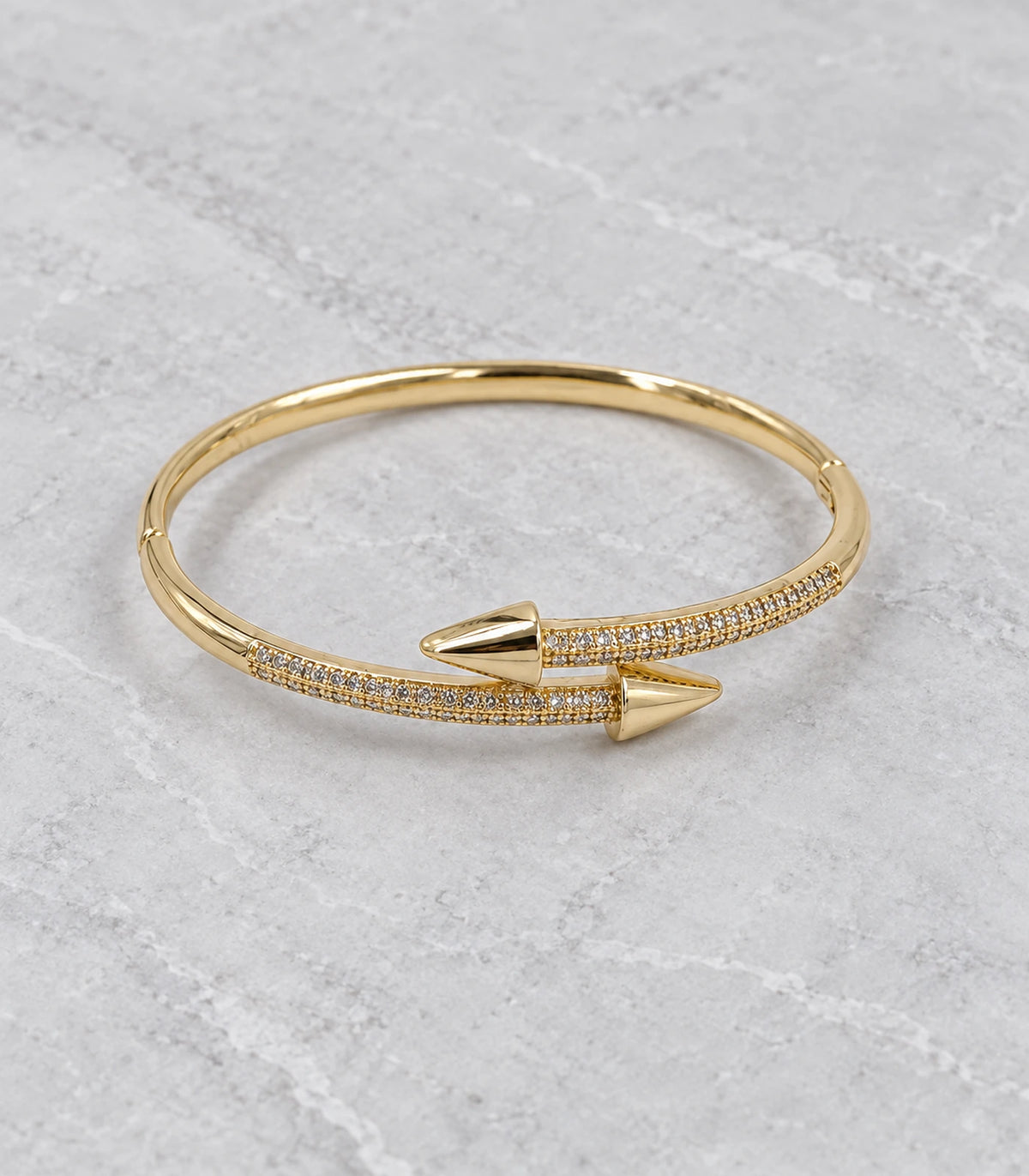 JIMIKI Gold-Tone Double Row Pavé Spear Wrap Bangle — bangle in a styled flat lay #color_gold-tone / clear
