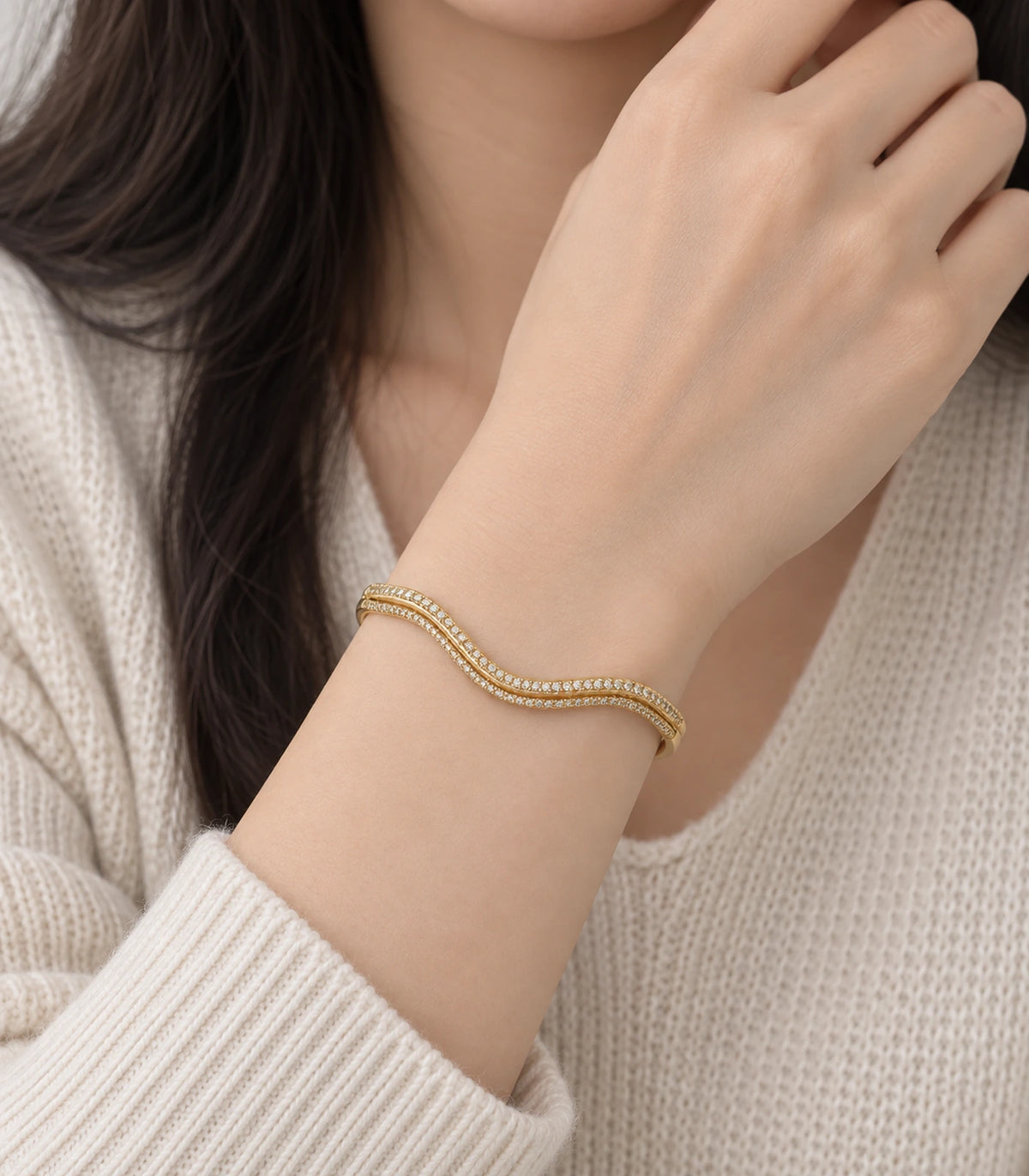 JIMIKI Gold-Tone Double Wave Pavé Bangle — worn on the wrist #color_gold-tone / clear