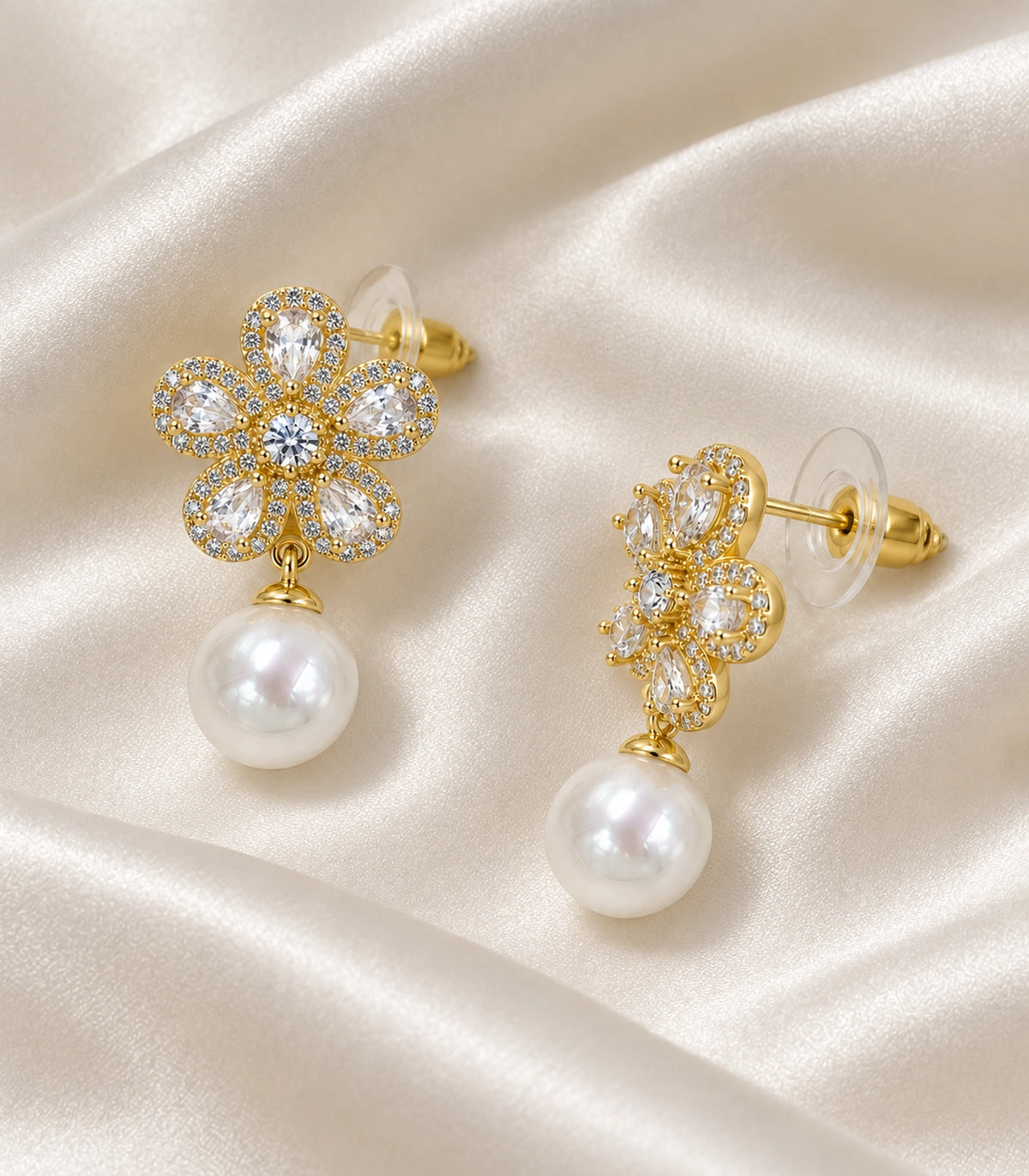JIMIKI Five Petal Crystal Flower Pearl Drop Earring Pair in Gold-tone, editorial flat lay #color_gold-tone