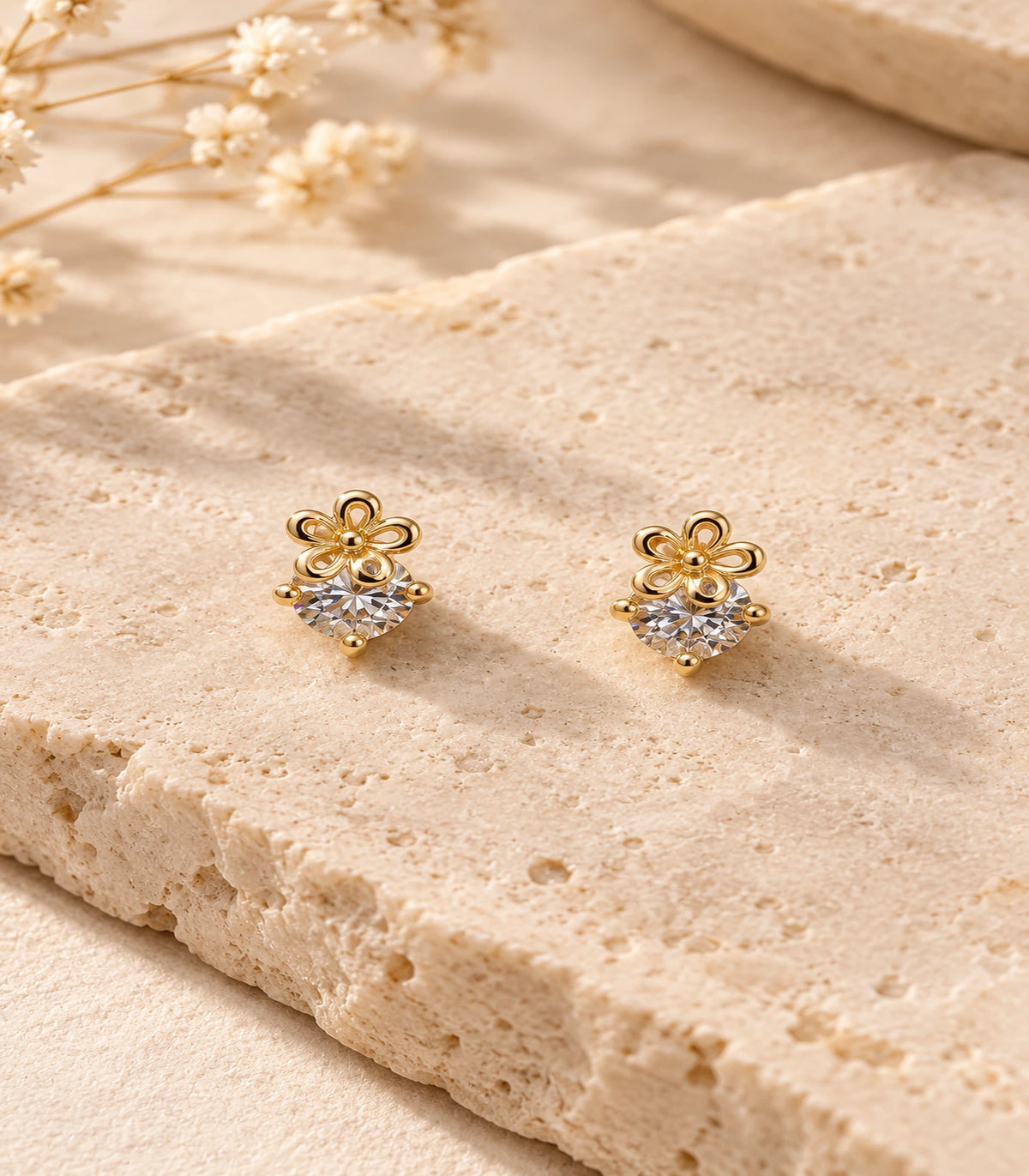 JIMIKI Gold Tone Flower Solitaire Stud Earrings — editorial flat lay #color_gold-tone
