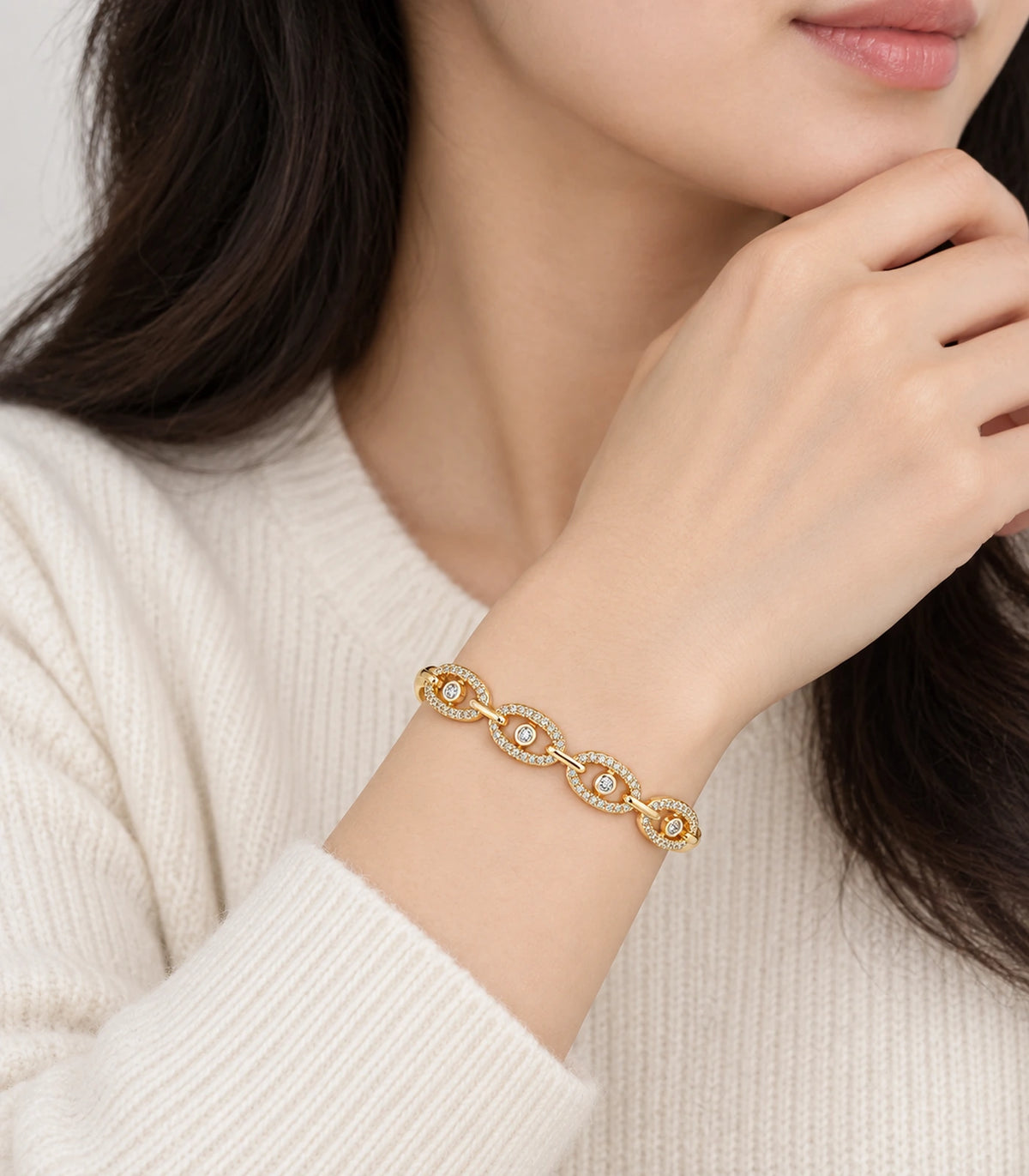 JIMIKI Gold-Tone Four Oval Halo Crystal Bangle — worn on the wrist #color_gold-tone / clear