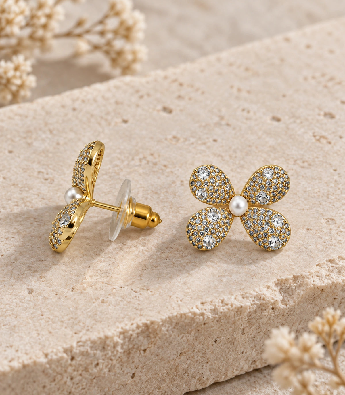 JIMIKI Four Petal Pave Pearl Centre Stud Earring Pair in Gold tone, editorial flat lay #color_gold tone