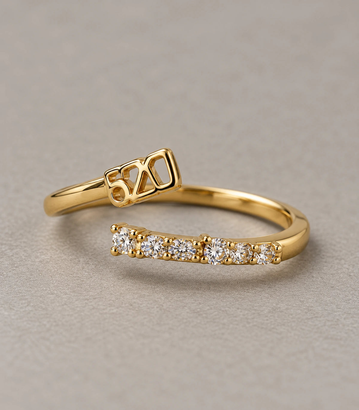 Gold Tone Geometric Pave Open Ring — Close-up product detail on a grey surface
