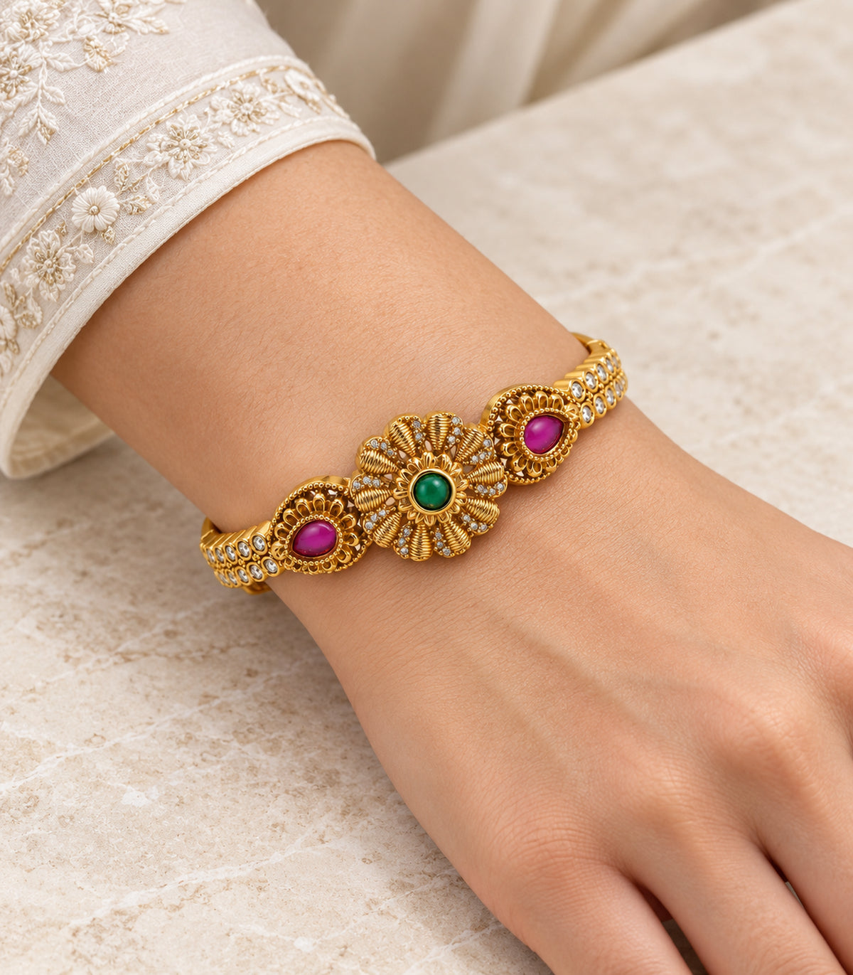 Gold-tone green flower and magenta teardrop single bangle — model view