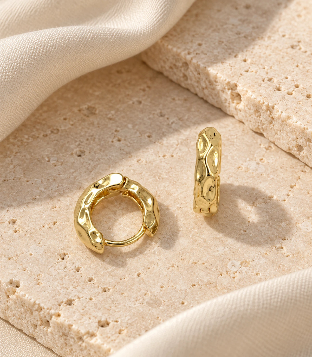 JIMIKI Gold Tone Hammered Hoop Earrings, editorial flatlay pair #color_gold-tone