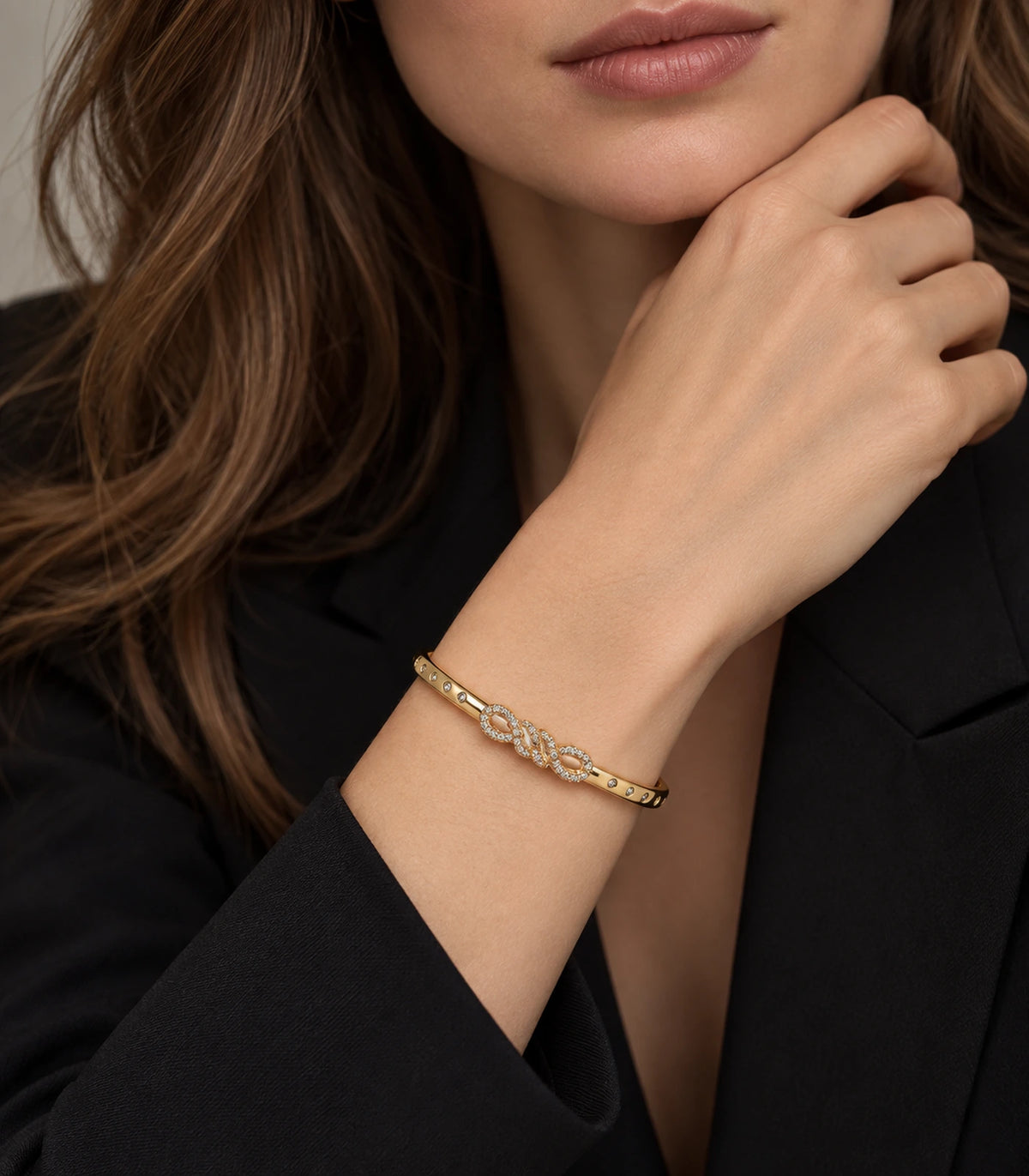 JIMIKI Gold-Tone Infinity Knot Bezel Stone Bangle — bangle styled with an outfit #color_gold-tone / clear