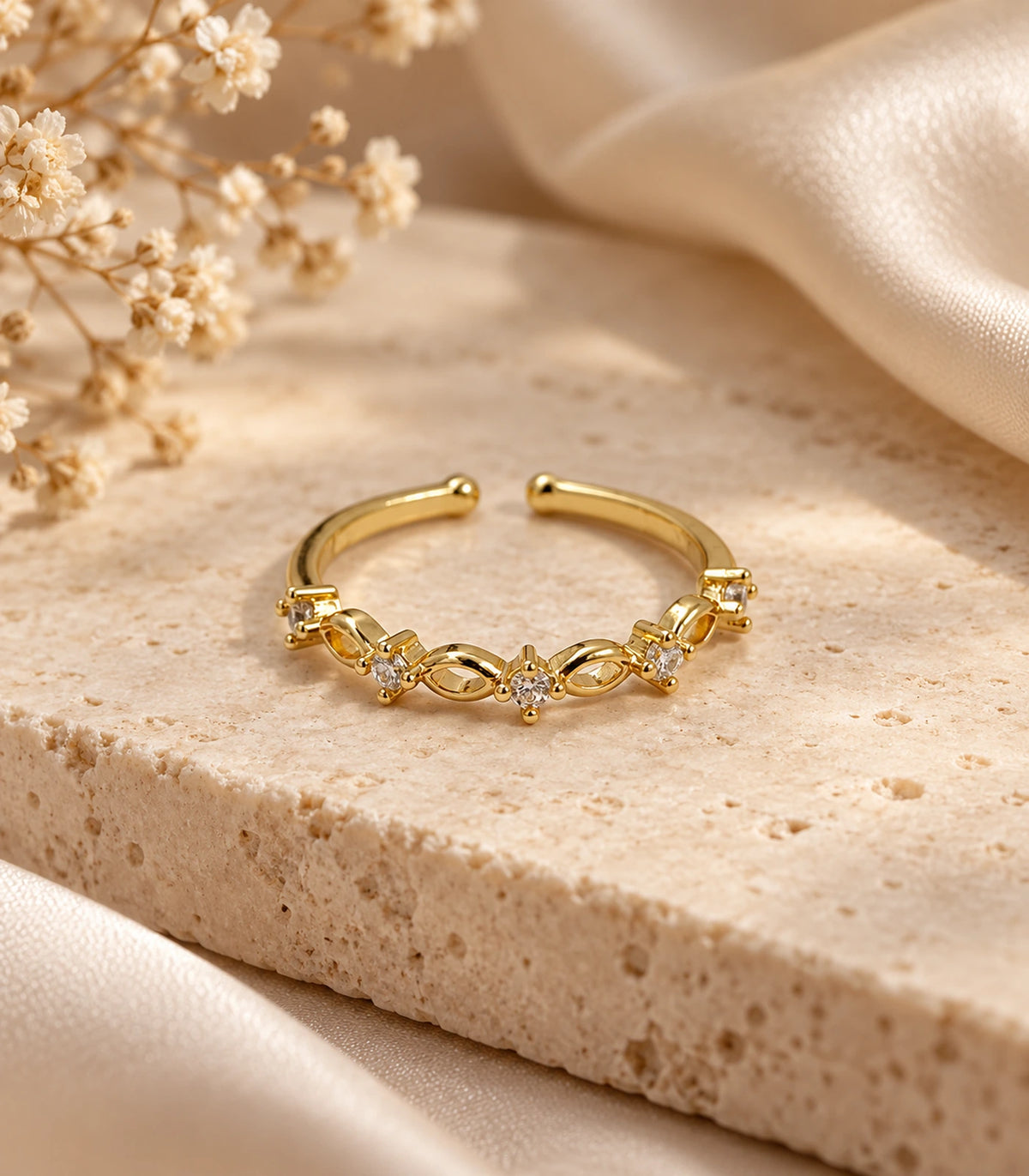 JIMIKI Gold Tone Linked Leaf Crystal Ring in Gold Tone - editorial flatlay #color_gold-tone