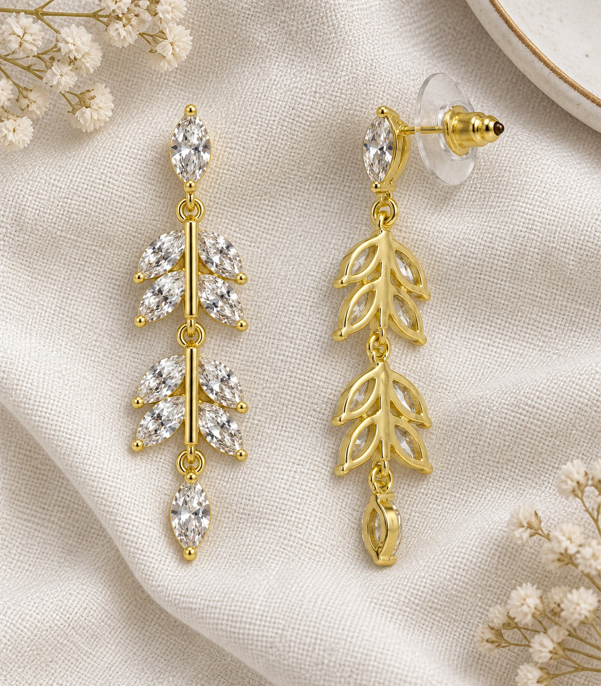 JIMIKI Marquise Crystal Leaf Drop Earring Pair in Gold tone, editorial flat lay #color_gold tone