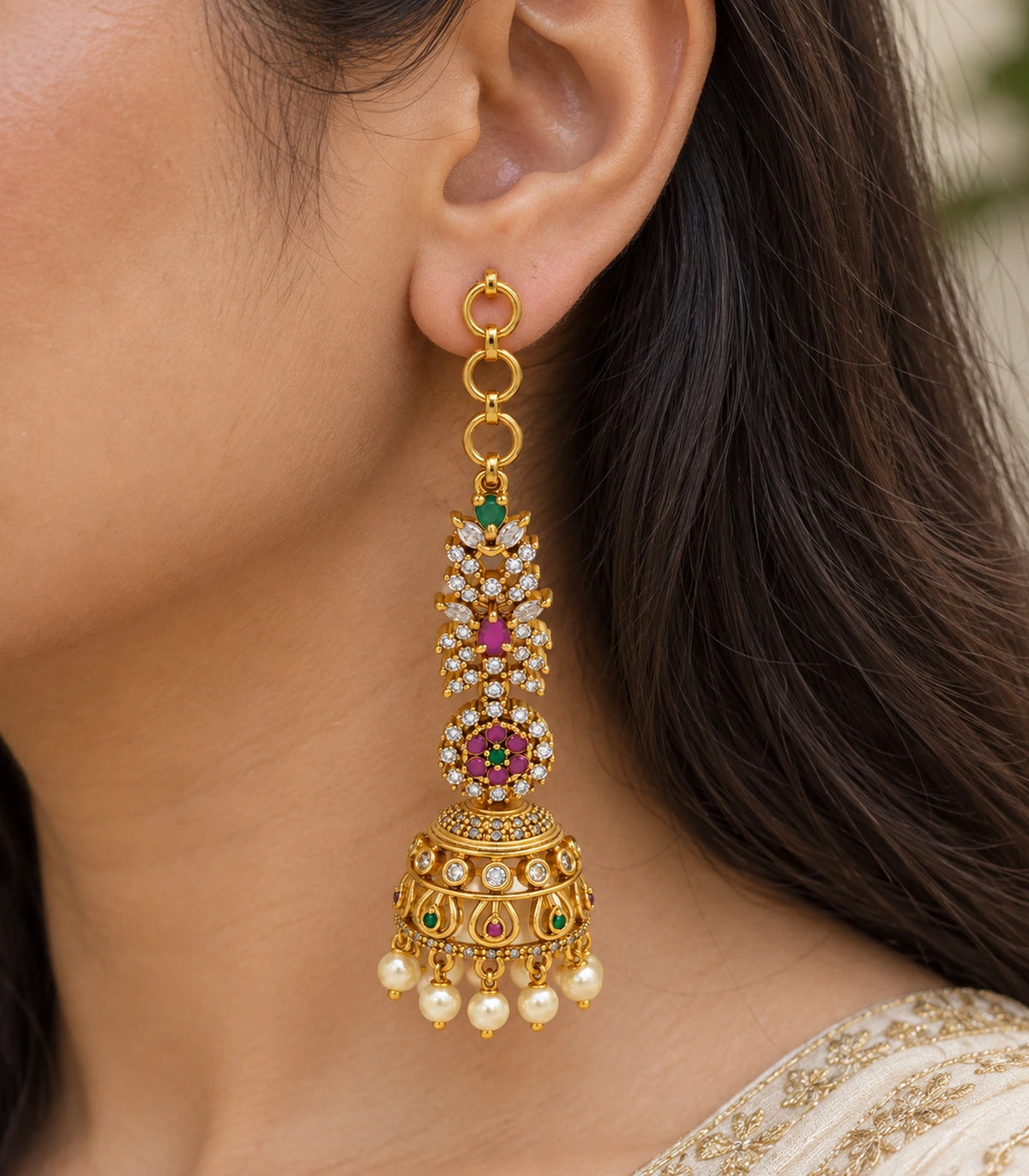 Closeup of the multicolor crystal-style details and bell shape of the jhumka earring