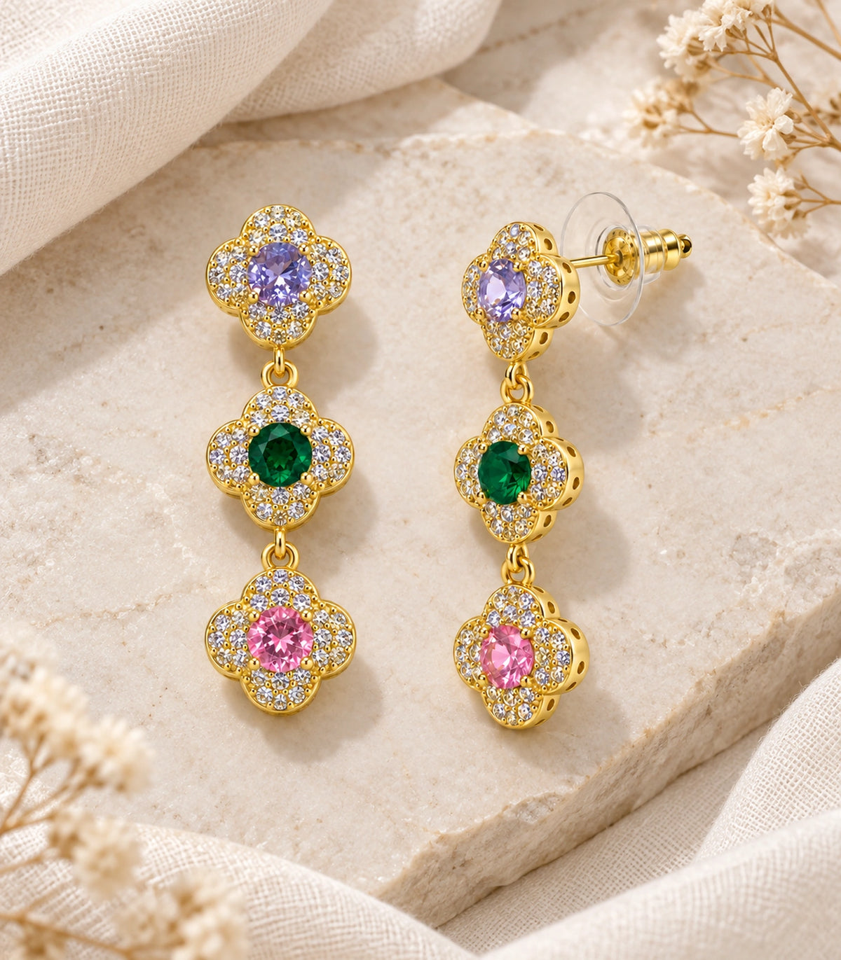 JIMIKI Gold Tone Multicolour Triple Clover Halo Drop Earring Pair in Gold tone / multicolour, editorial flat lay