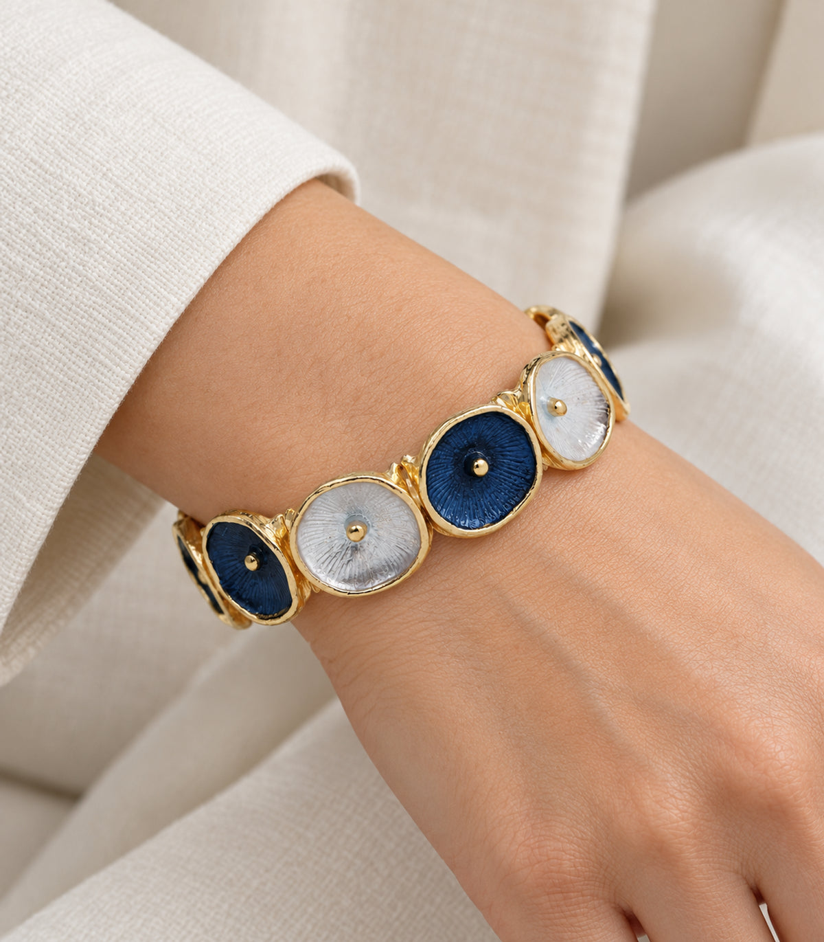 JIMIKI gold-tone navy and white oval disc bracelet — closeup