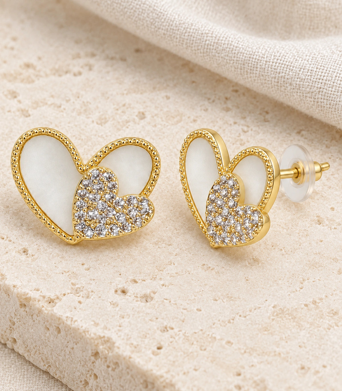JIMIKI Open Heart Pave Heart Stud Earring Pair in Gold tone, editorial flat lay #color_gold tone