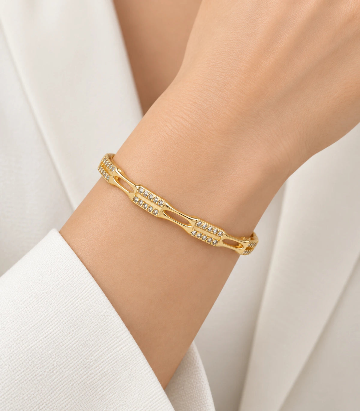 JIMIKI Gold-Tone Open Link Double Row Crystal Bangle — worn on the wrist #color_gold-tone / clear