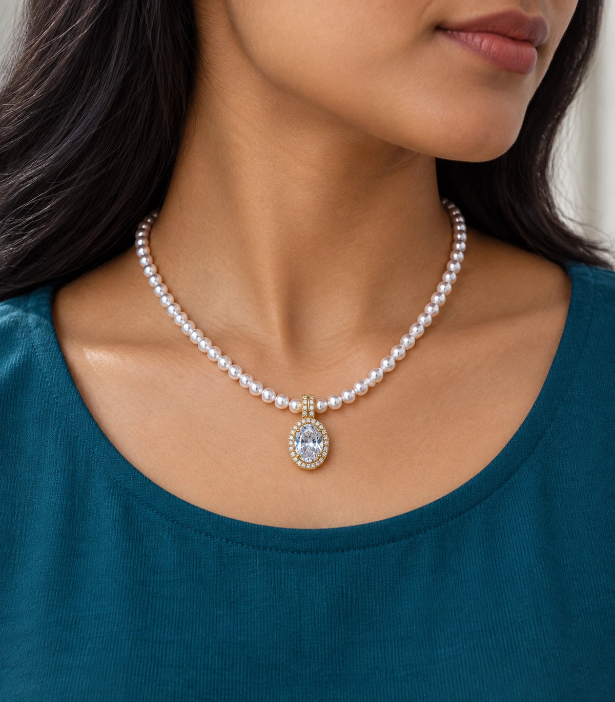 JIMIKI Gold Tone Oval Halo Crystal Pearl Style Necklace in Gold / White, editorial model view