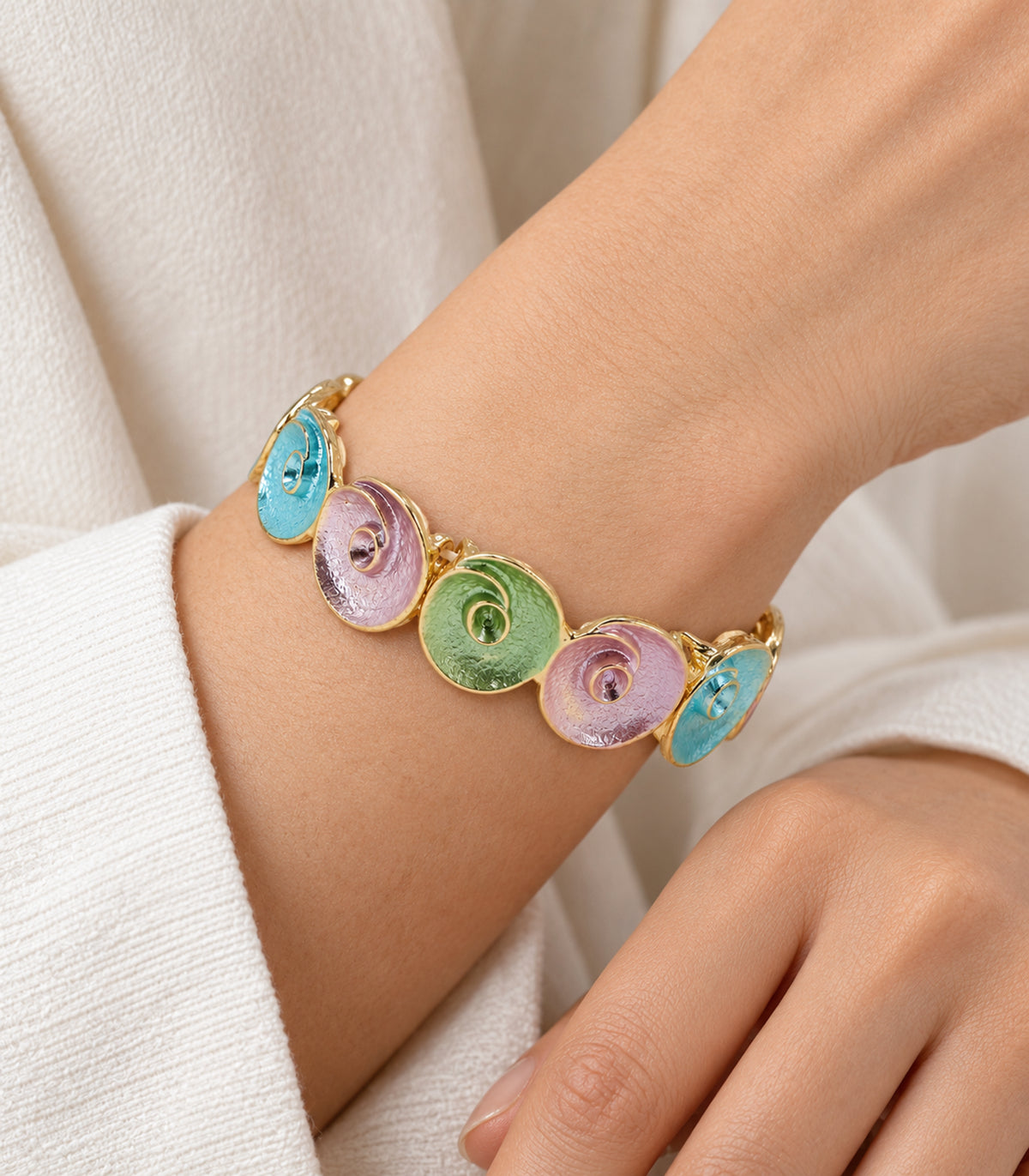 Gold-tone pastel spiral disc bracelet - closeup view, one bracelet