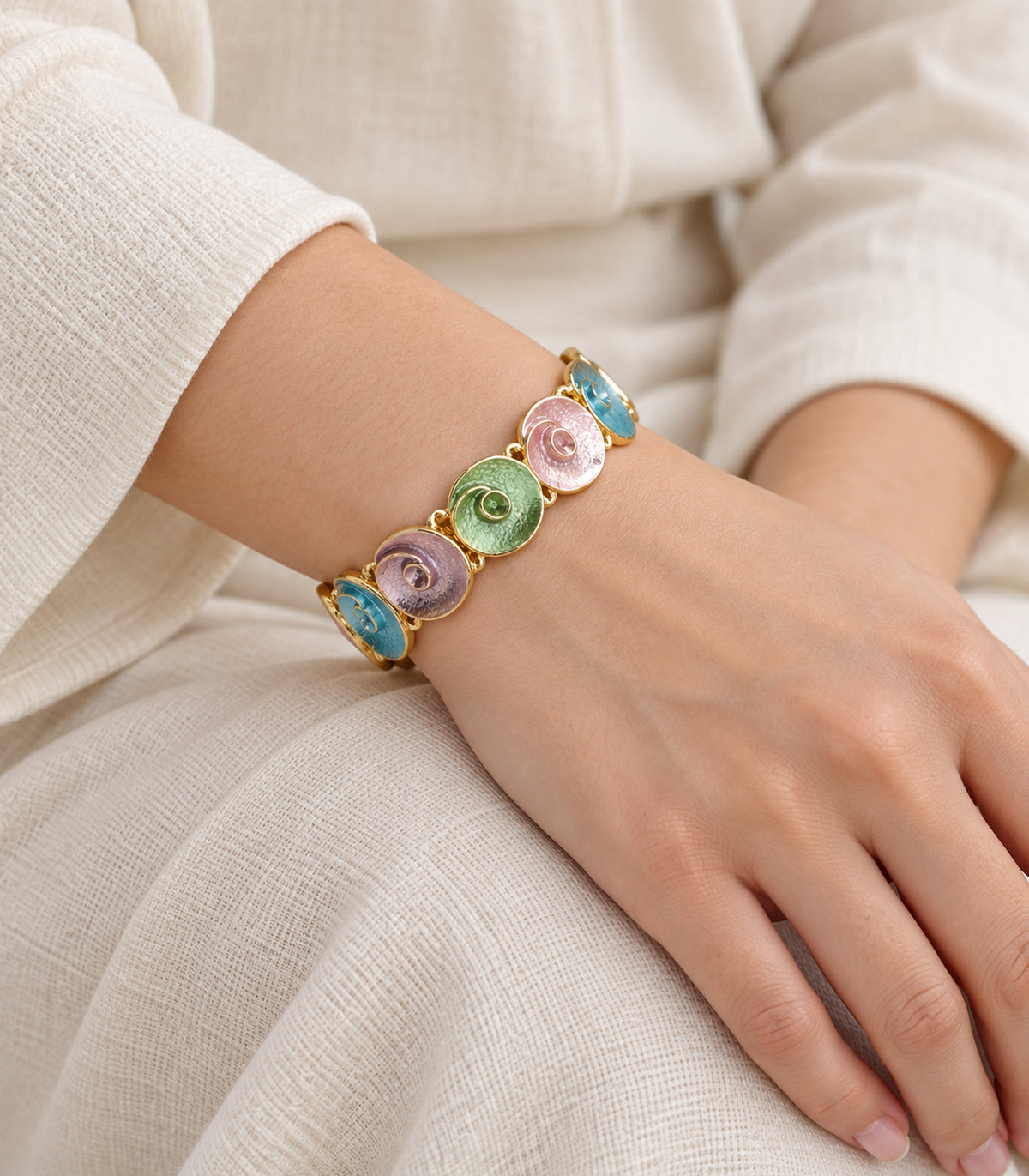 Gold-tone pastel spiral disc bracelet - model view, one bracelet