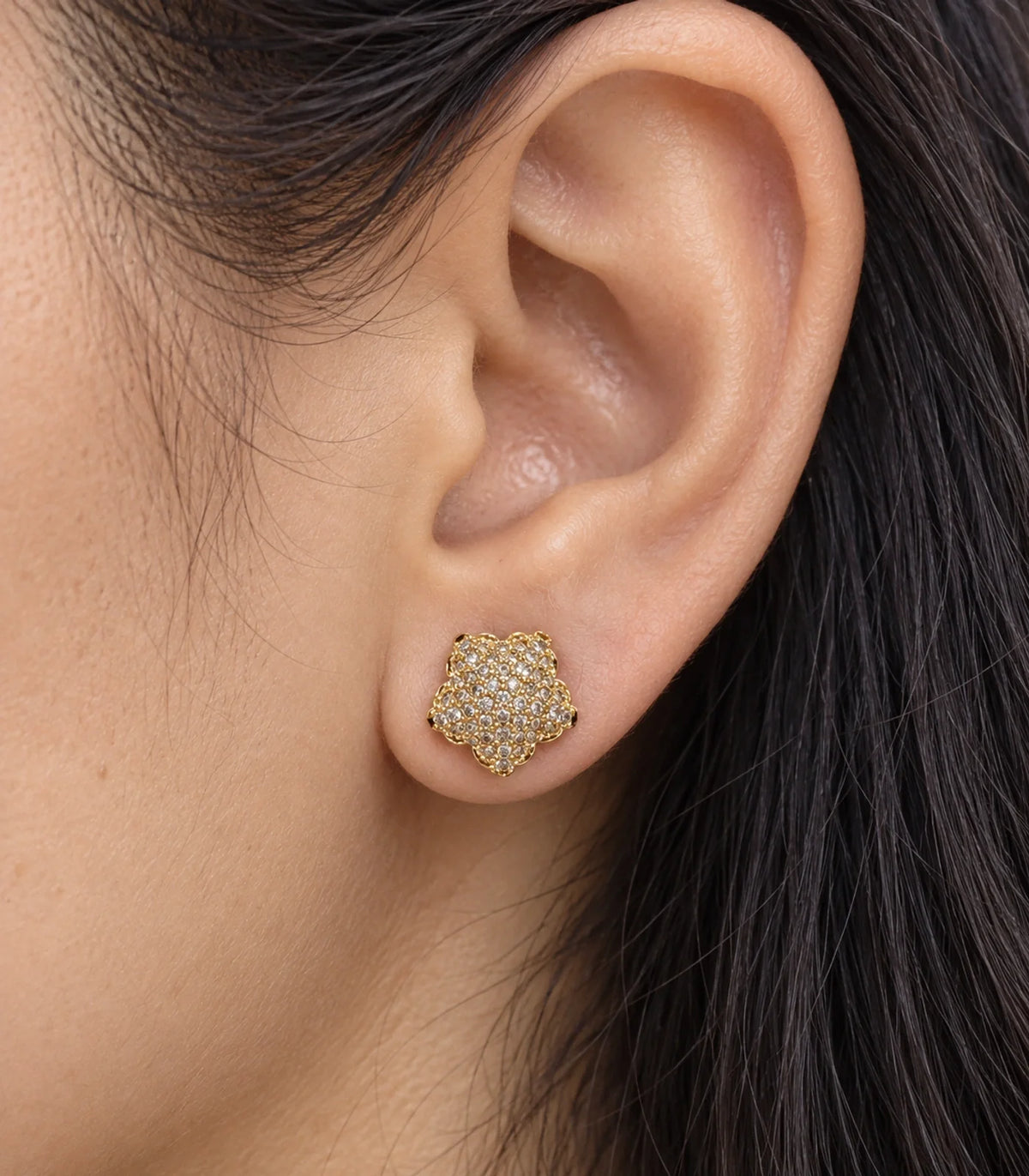 JIMIKI Gold Tone Pave Flower Stud Earrings - worn close-up showing earring detail #color_gold-tone