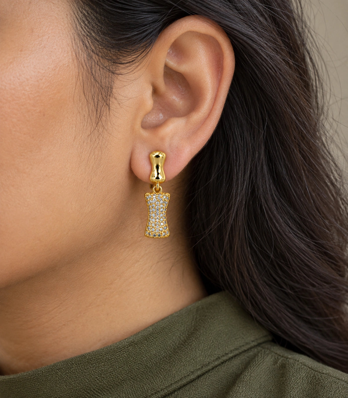 JIMIKI Pave Hourglass Drop Earring Pair in Gold tone, model wearing view #color_gold tone