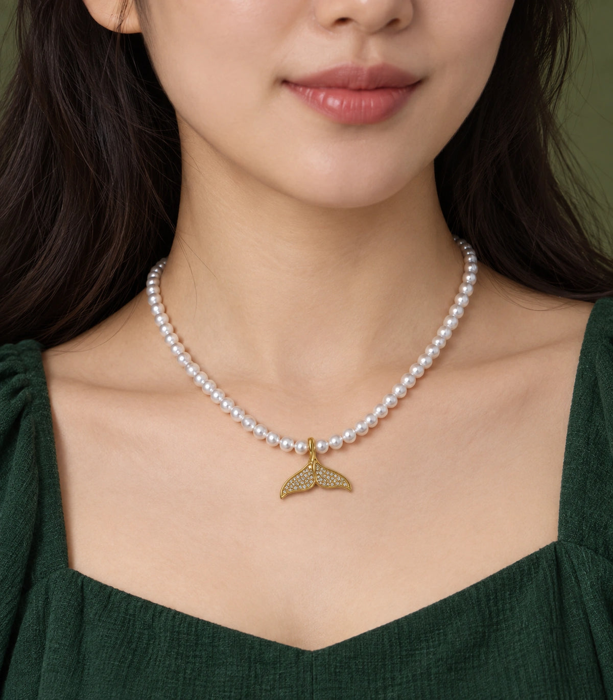 JIMIKI Pavé Whale Tail Pearl Necklace in Gold-tone, close-up of the pendant and pearl-style strand #color_gold-tone