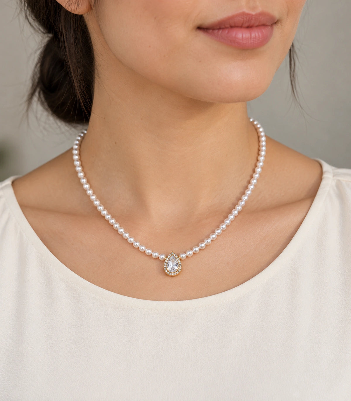 JIMIKI Gold Tone Pear Halo Crystal Pearl Style Necklace in Gold tone / white, editorial model view