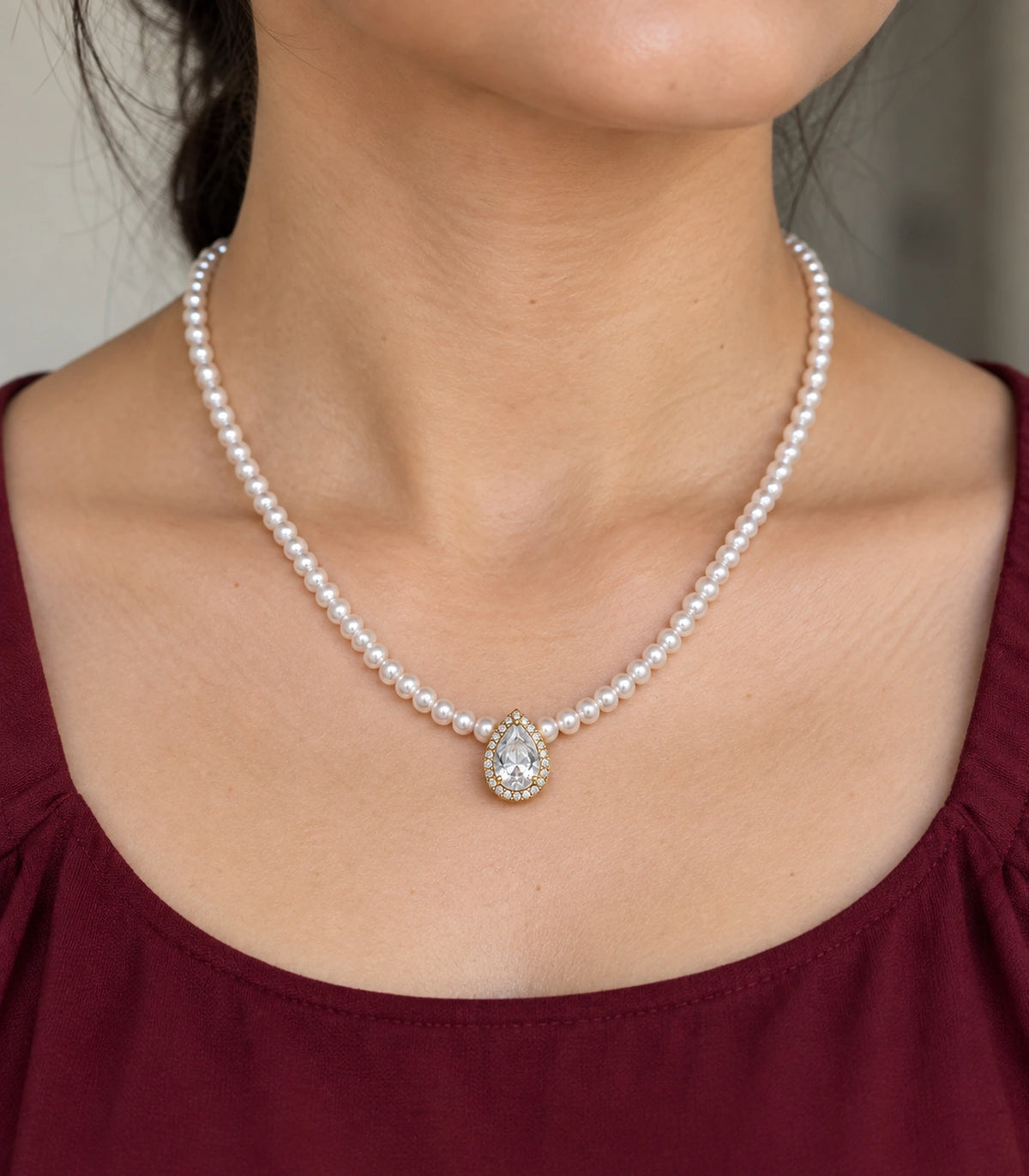 JIMIKI Gold Tone Pear Halo Crystal Pearl Style Necklace in Gold tone / white, model wearing view