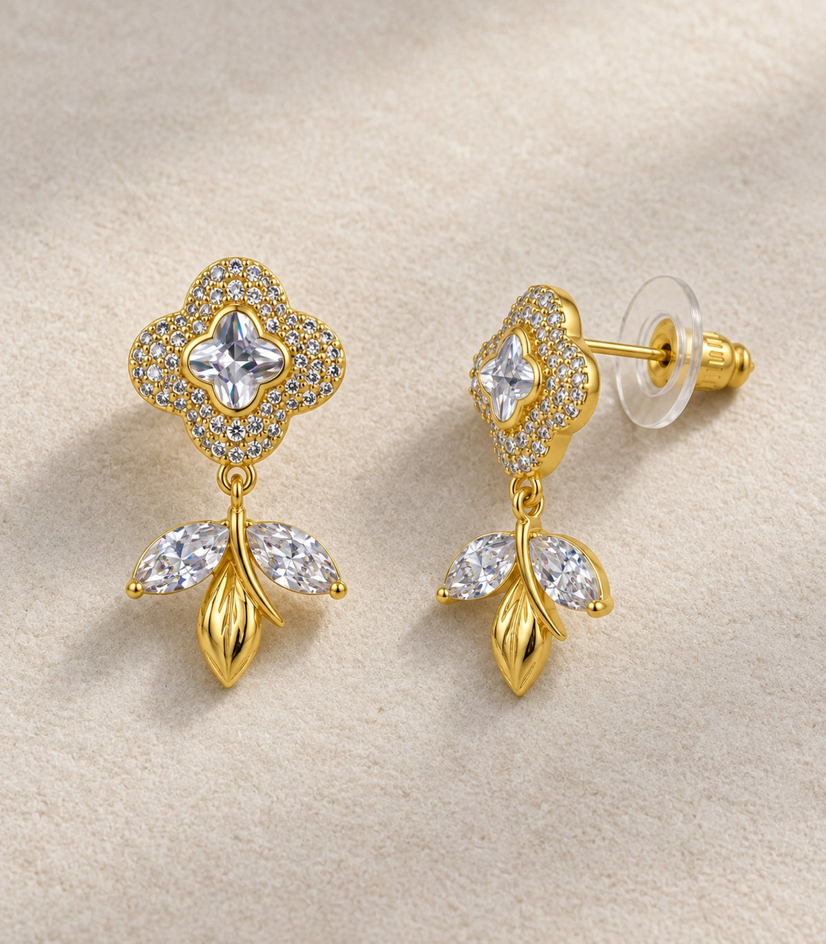 JIMIKI Quatrefoil Crystal Leaf Drop Earring Pair in Gold Tone, editorial flat lay #color_gold tone