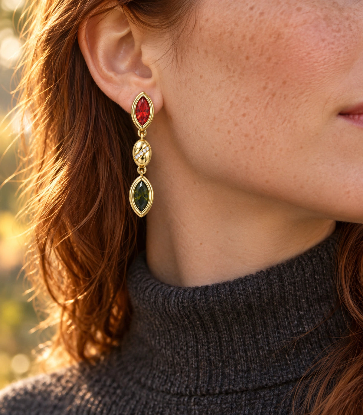 JIMIKI Marquise Crystal Oval Link Drop Earring Pair in Gold-tone / Red / Olive green, editorial model view #color_gold-tone / red / olive green