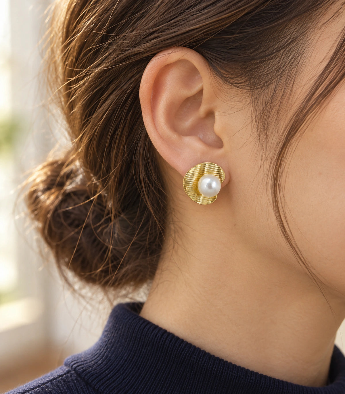 JIMIKI Ribbed Curved Disc Pearl Stud Earring Pair in Gold tone / White, editorial model view #color_gold tone / white