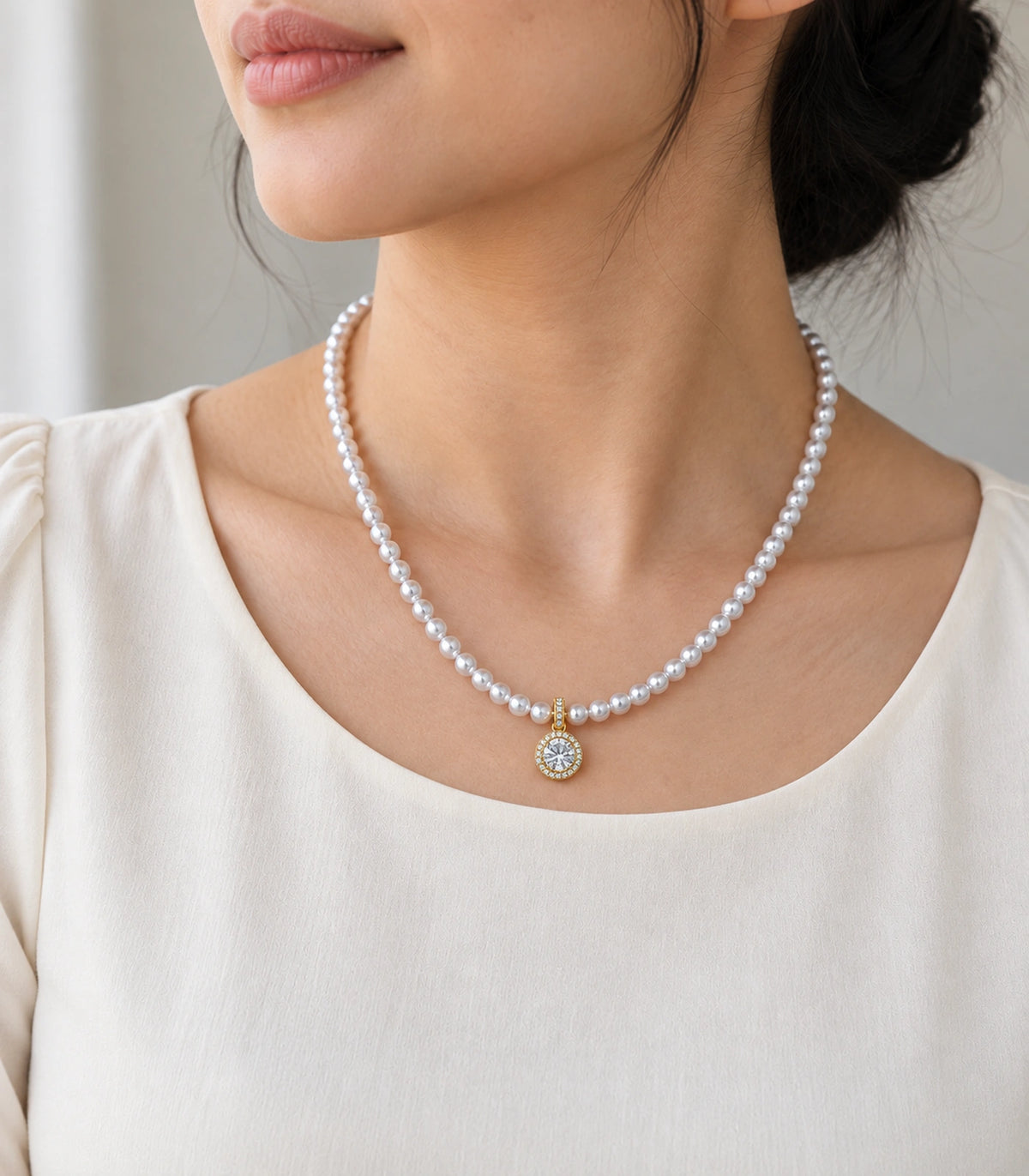 JIMIKI Gold Tone Round Halo Crystal Pearl Style Necklace in Gold tone / white, editorial model view