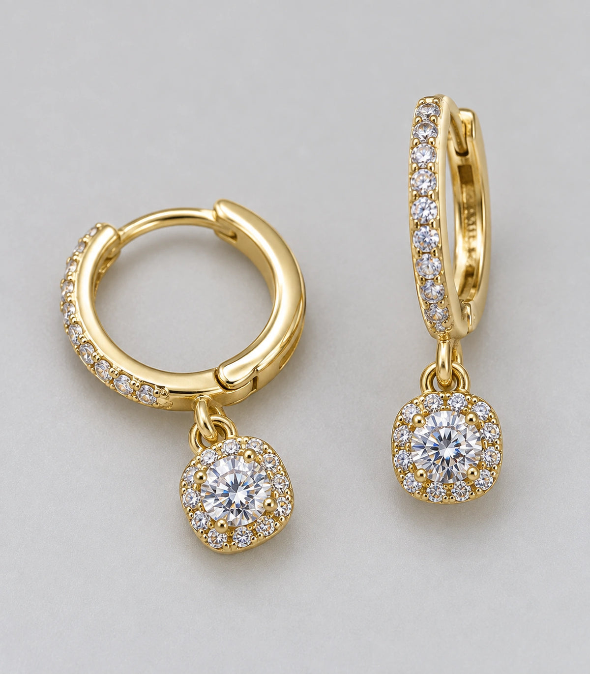 JIMIKI Gold-Tone Round Halo Solitaire Drop Huggie Earrings in Gold / Clear, close-up detail