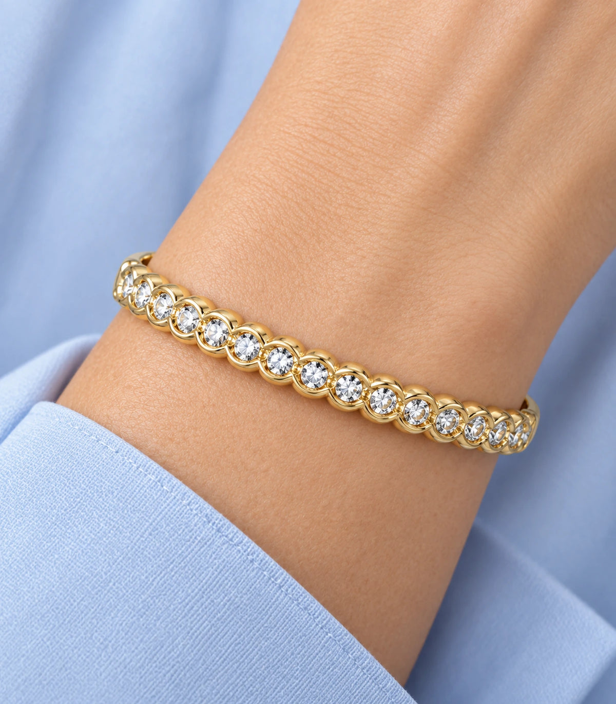 JIMIKI Gold-Tone Scalloped Bezel Crystal Bangle — close-up of the bangle worn on the wrist #color_gold-tone / clear