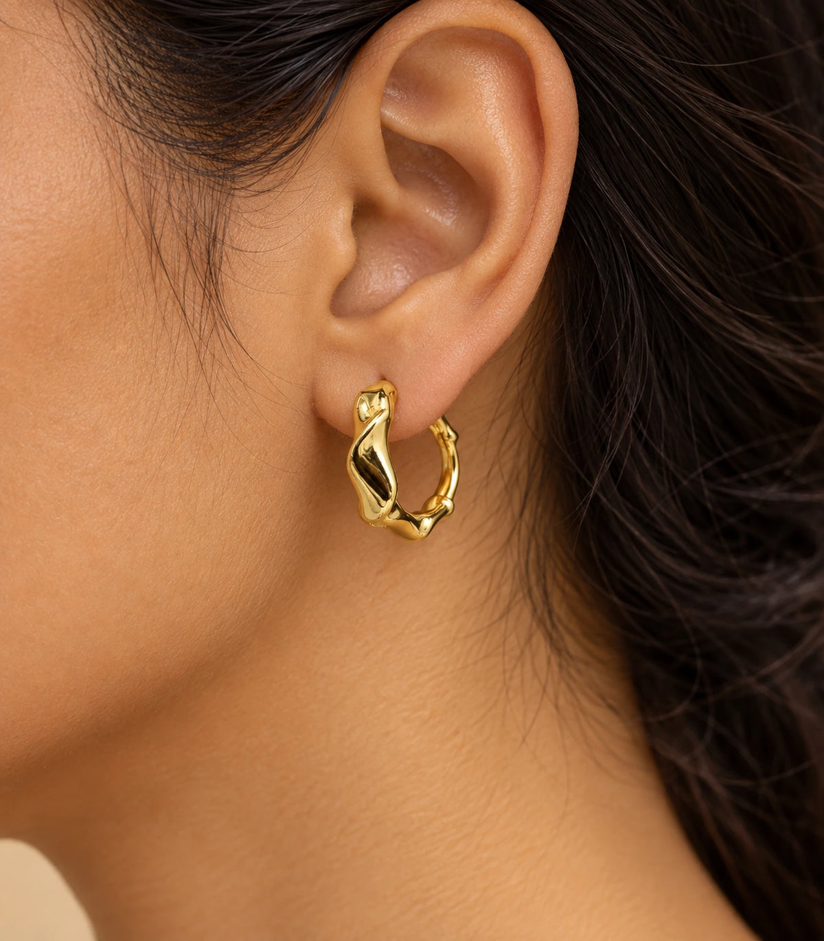 JIMIKI Gold Tone Sculpted Twist Hoop Earrings in Gold Tone - editorial model #color_gold-tone