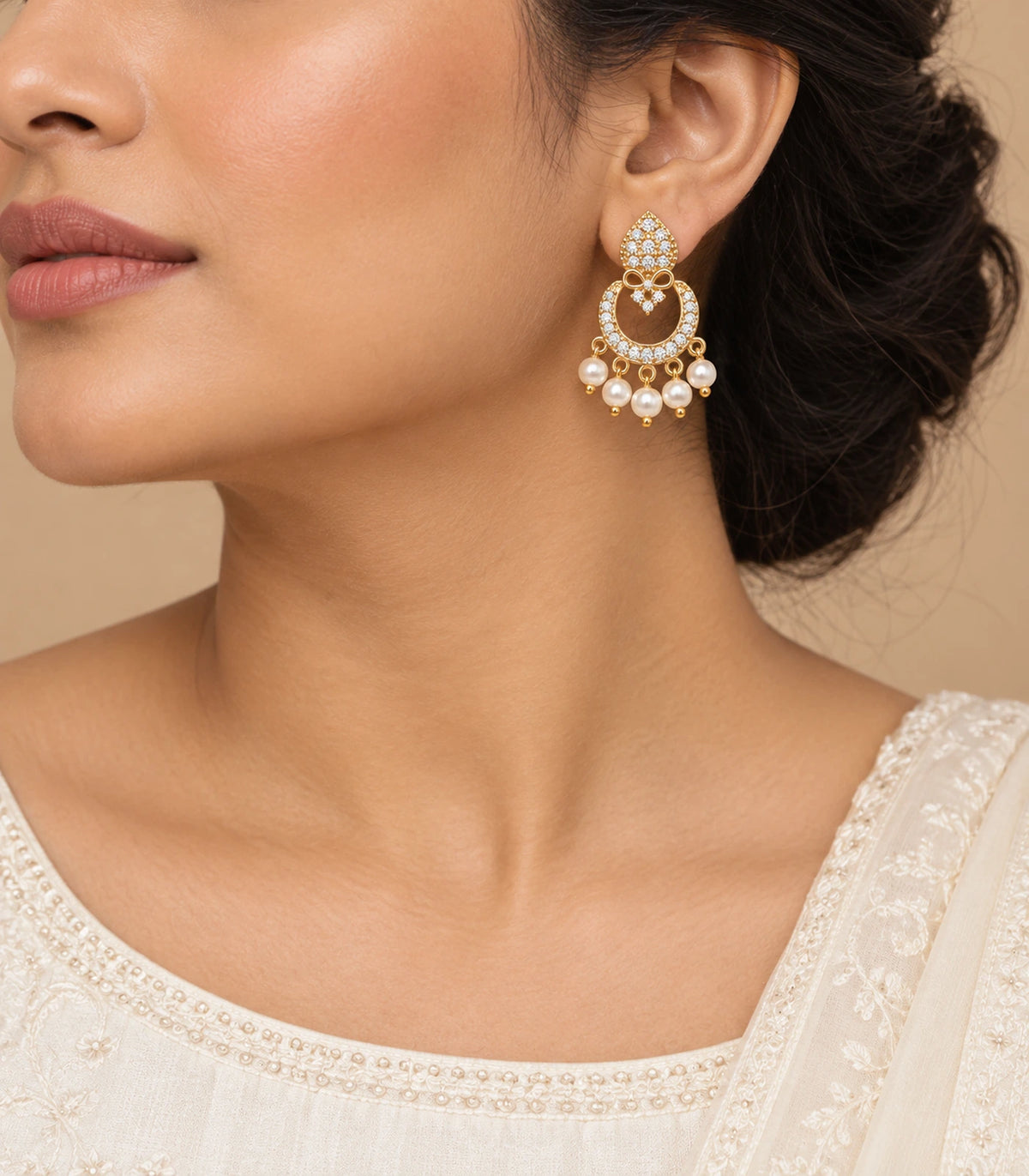 JIMIKI Gold-Tone Teardrop Bow Pearl Chandbali Earrings — worn on the ear #color_gold-tone / white