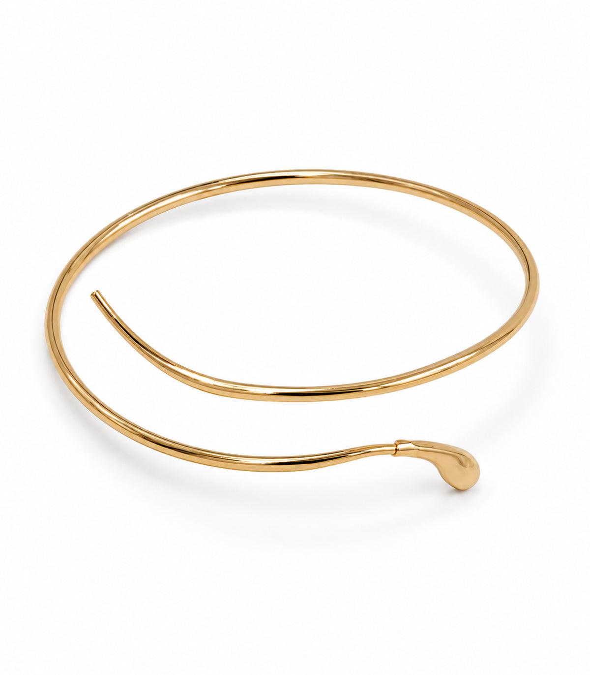 Gold-tone open spiral arm cuff with one teardrop tip and one plain tapered terminal on white