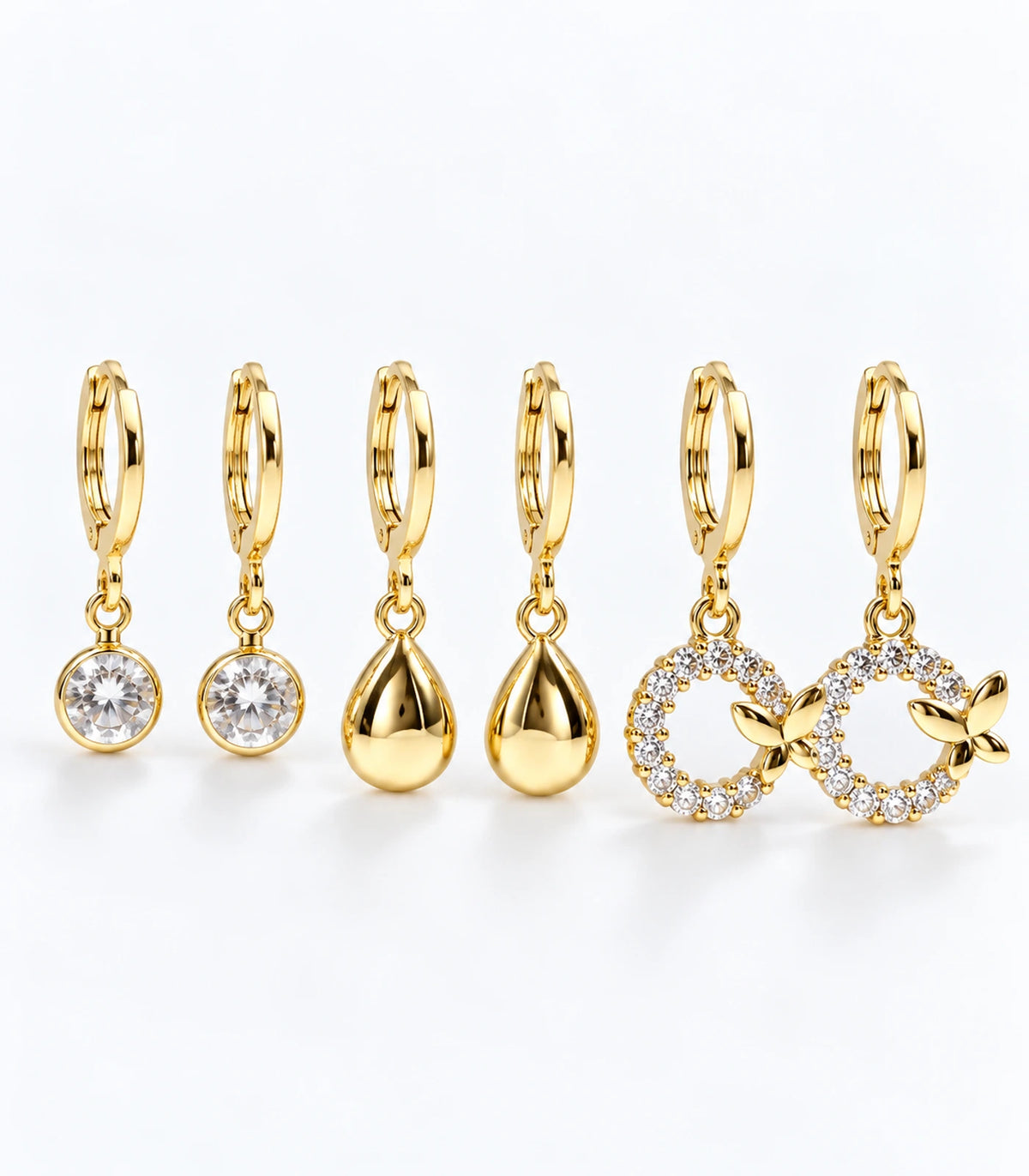 Full three-pair gold tone hoop earring set with clear crystal, teardrop and leaf wreath designs