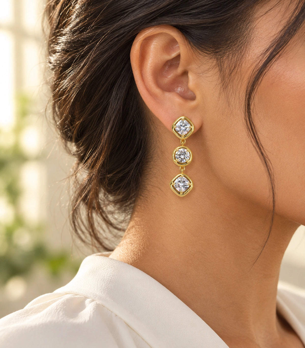JIMIKI Three Stone Crystal Drop Earring Pair in Gold tone, editorial model view #color_gold tone